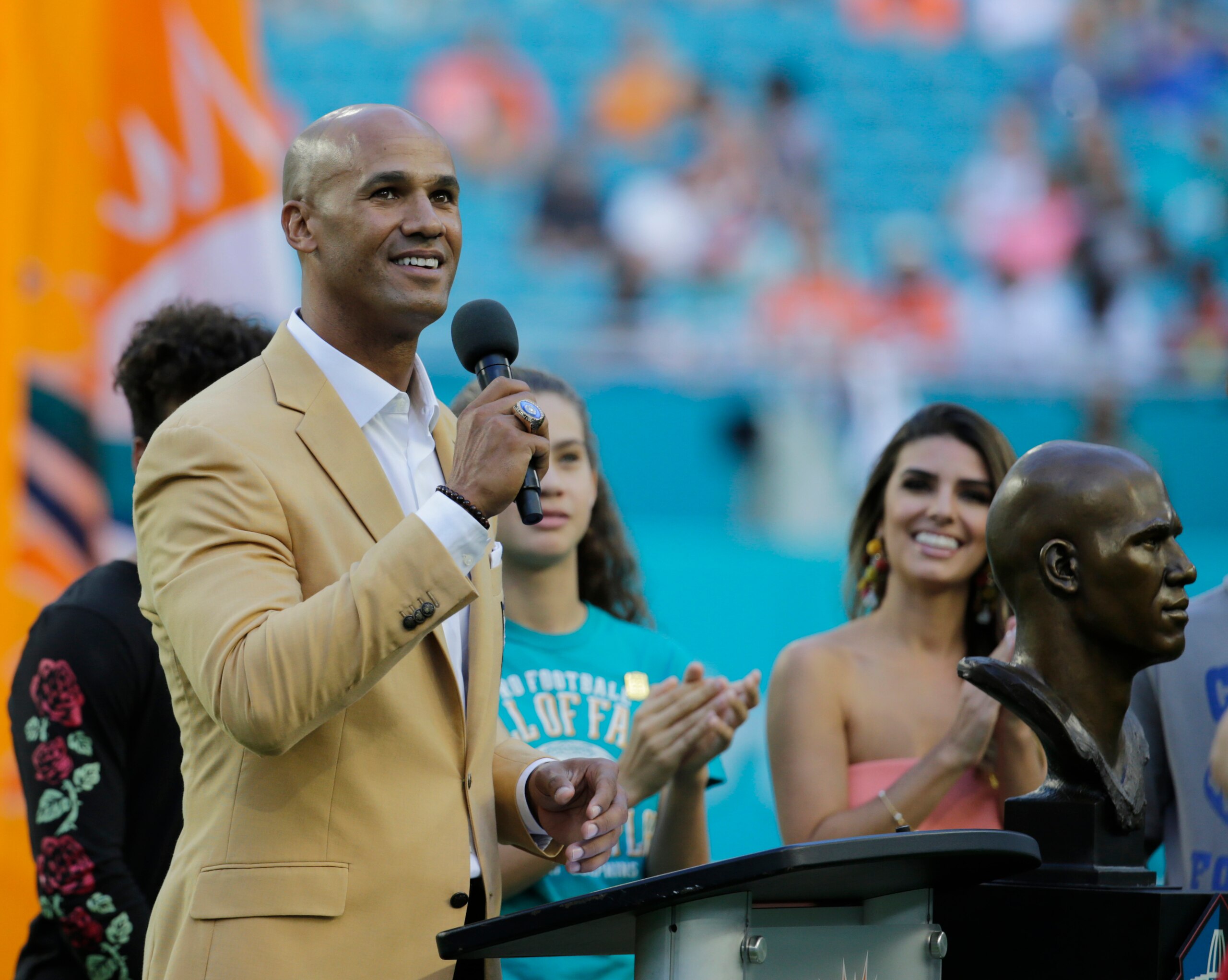 Former Miami Dolphins player Jason Taylor acknowledges the cheers from the crowd during a ceremony celebrating his induction into the Football Hall of Fame during the half time show at an NFL football game against the Denver Broncos, Sunday, Dec. 3, 2017, in Miami Gardens, Fla. (AP Photo/Lynne Sladky)