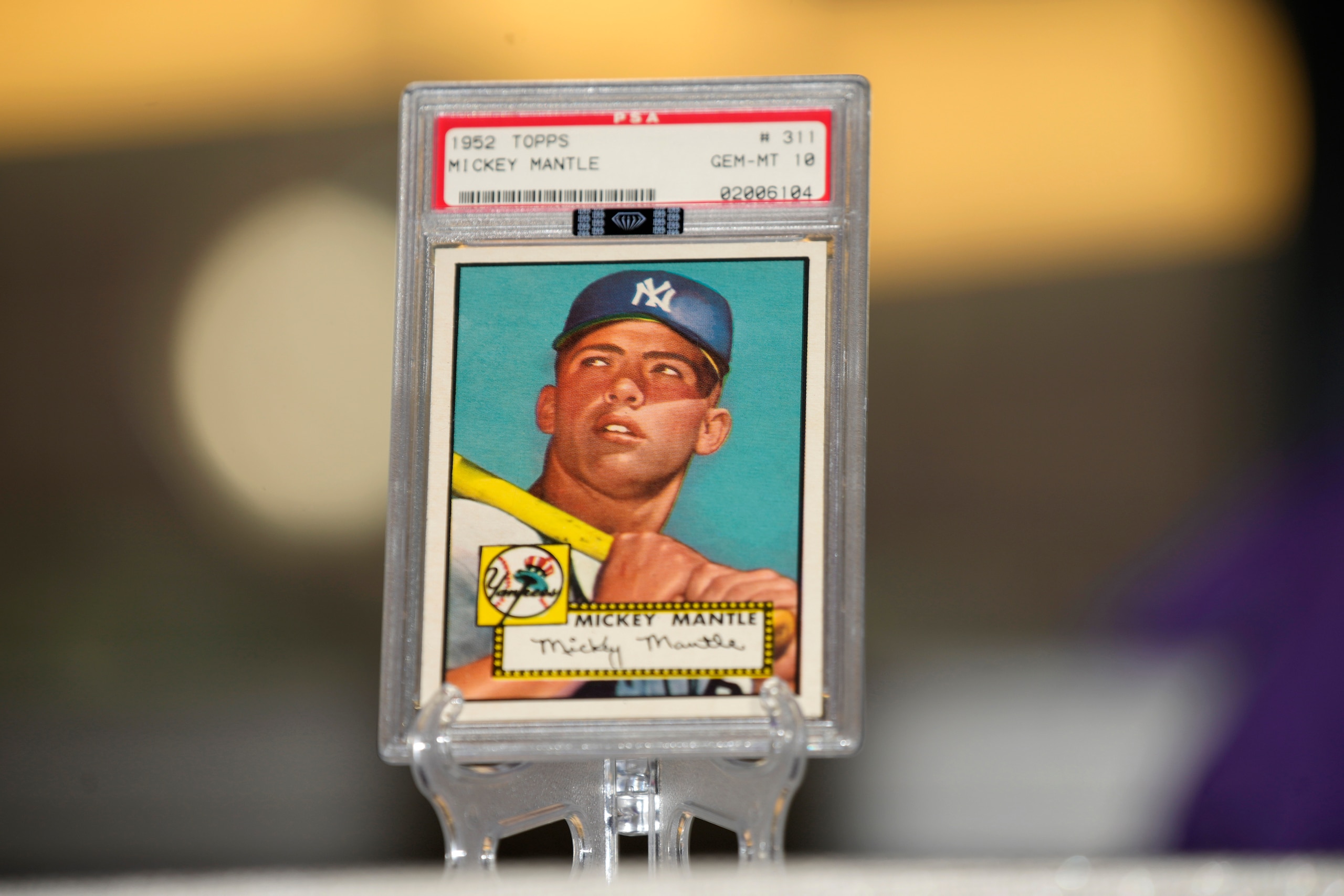 The most-sought after baseball card in the world, a PSA gem mint 10 1952 Topps Mickey Mantle card known as the Holy Grail of cards, sits on display in the Hall of Legends at the Rally Hotel as part of an exhibit of baseball memorabilia leading up to the playing of the Major League Baseball All Star Game on Saturday, July 10, 2021, in Denver. The card, owned by Denver attorney Marshall Fogel, is on display for three days as part of the exhibit staged by History Colorado and the Colorado Rockies Baseball Club Foundation. (AP Photo/David Zalubowski)
