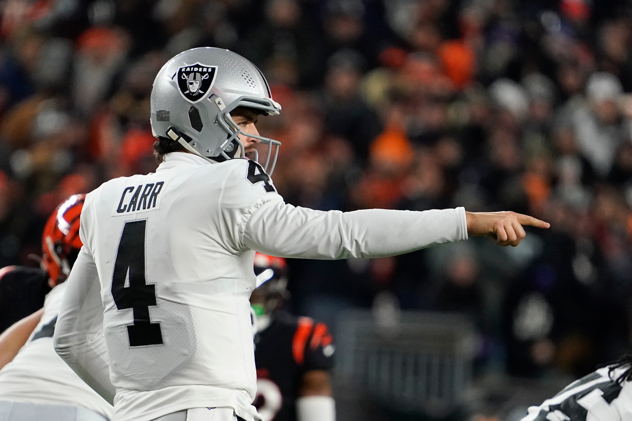 Las Vegas Raiders quarterback Derek Carr (4) calls a play during the second half of an NFL wild-card playoff football game against the Cincinnati Bengals, Saturday, Jan. 15, 2022, in Cincinnati. (AP Photo/Jeff Dean)