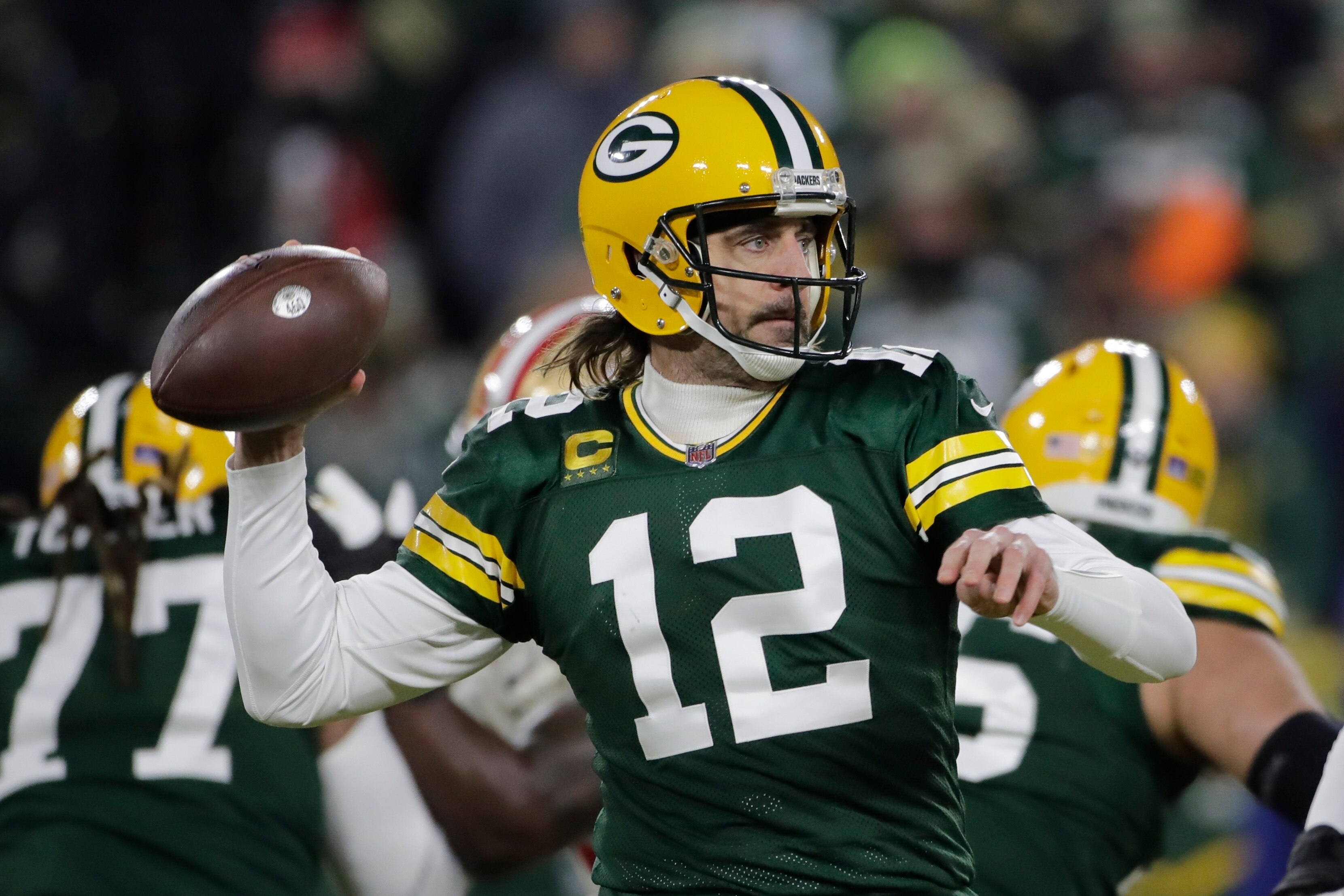 Green Bay Packers' Aaron Rodgers throws during the first half of an NFC divisional playoff NFL football game against the San Francisco 49ers Saturday, Jan. 22, 2022, in Green Bay, Wis. (AP Photo/Aaron Gash) Green Bay Packers' Aaron Rodgers throws during the first half of an NFC divisional playoff NFL football game against the San Francisco 49ers Saturday, Jan. 22, 2022, in Green Bay, Wis. (AP Photo/Aaron Gash)