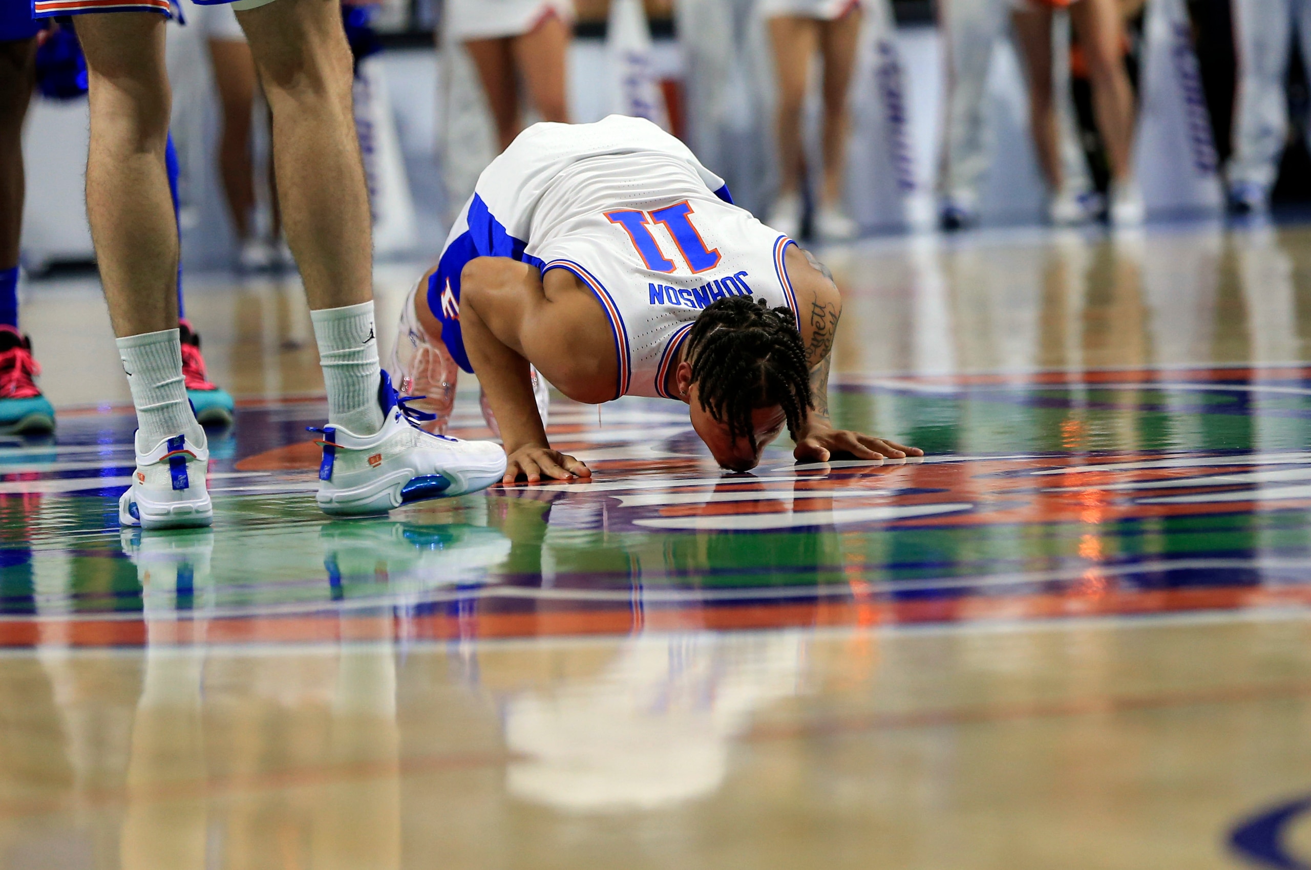 Florida forward Keyontae Johnson (11) kisses the floor at midcourt after being introduced as a starter before an NCAA college basketball game against Kentucky, Saturday, March 5, 2022, in Gainesville, Fla. (AP Photo/Matt Stamey) Florida forward Keyontae Johnson (11) kisses the floor at midcourt after being introduced as a starter before an NCAA college basketball game against Kentucky, Saturday, March 5, 2022, in Gainesville, Fla. (AP Photo/Matt Stamey)