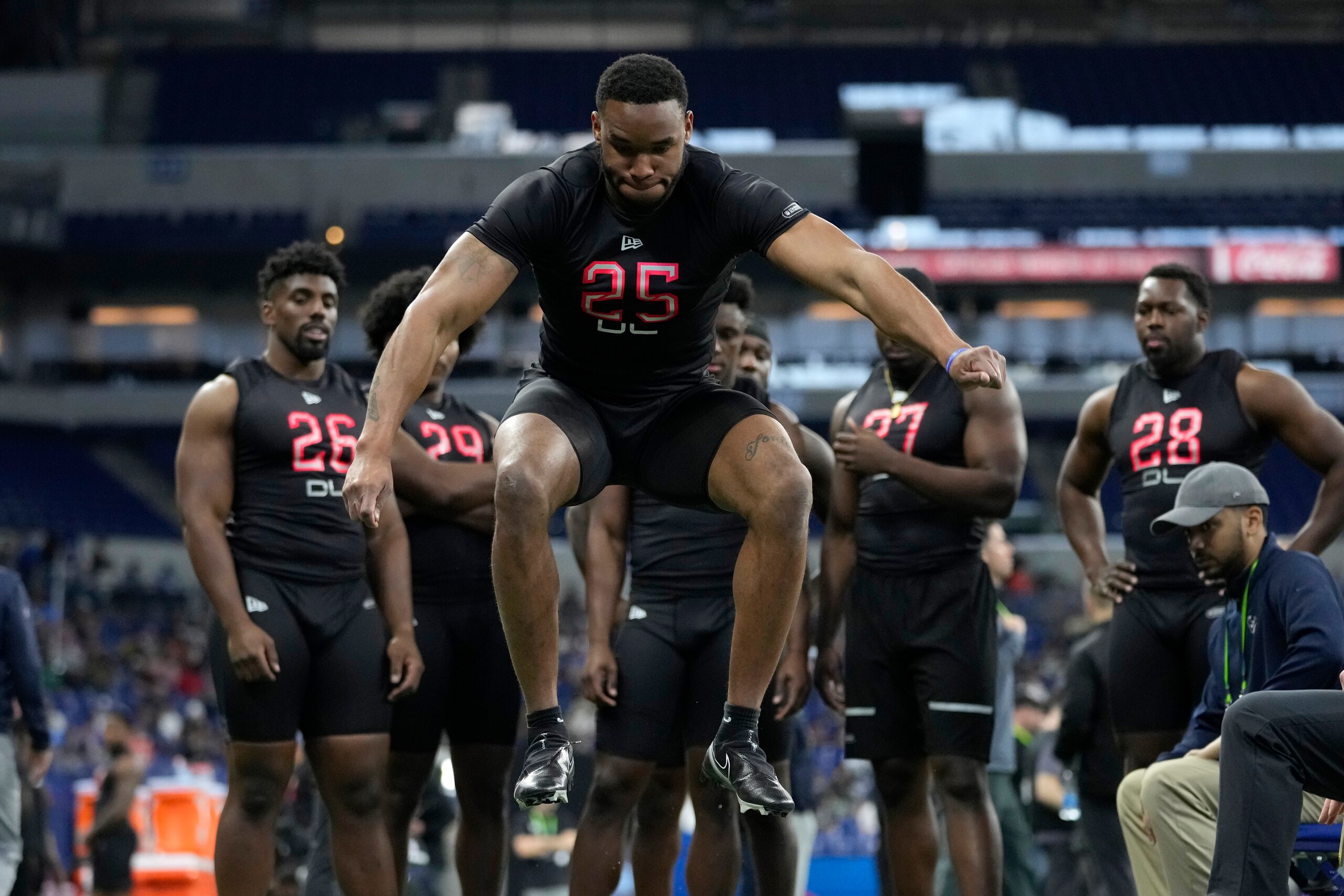 Virginia Tech defensive lineman Amaré Barno leaps during the broad jump at the NFL football scouting combine, Saturday, March 5, 2022, in Indianapolis. (AP Photo/Charlie Neibergall)