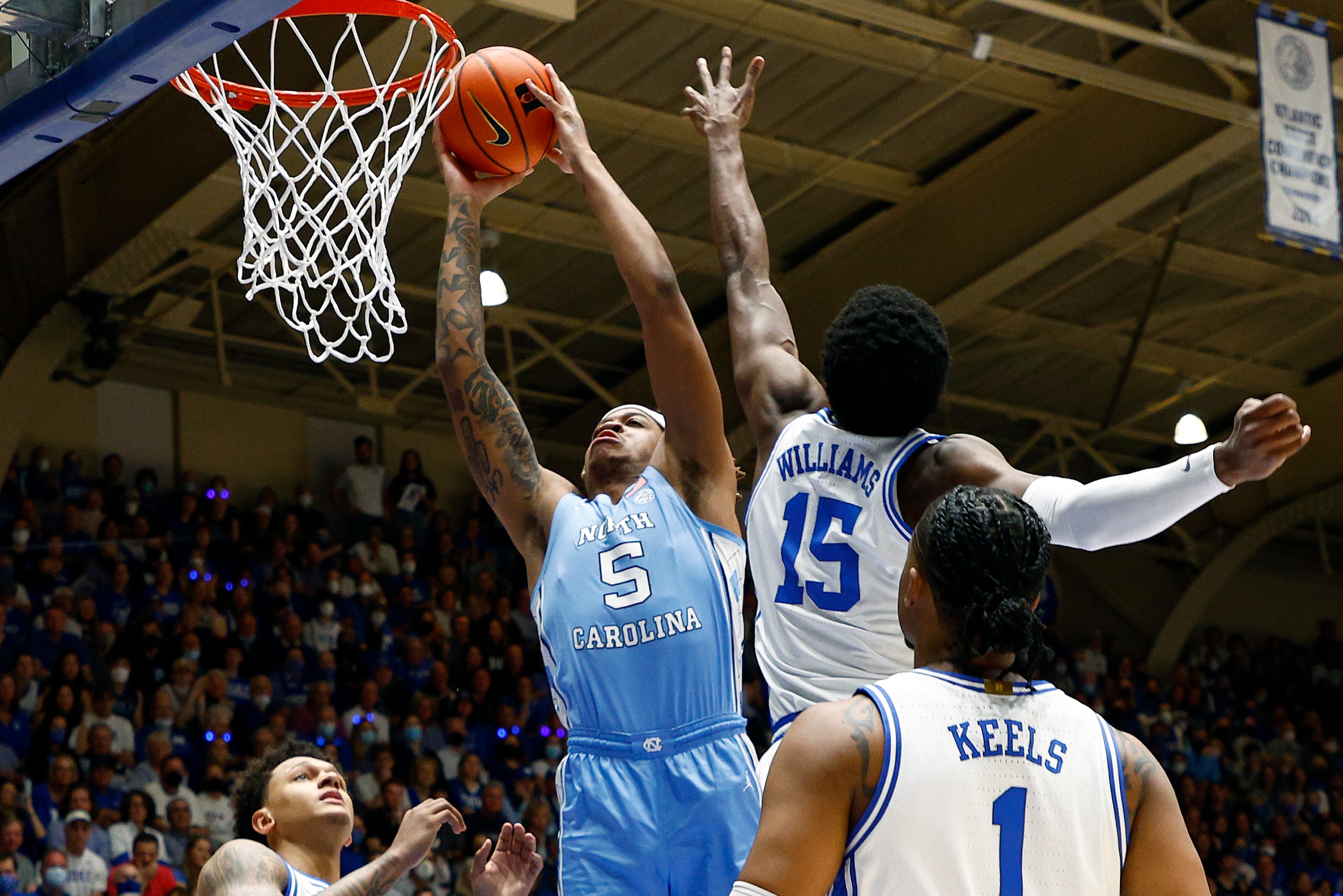 DURHAM, NORTH CAROLINA - MARCH 05: Armando Bacot #5 of the North Carolina Tar Heels dunks past Mark Williams #15 of the Duke Blue Devils during the first half at Cameron Indoor Stadium on March 05, 2022 in Durham, North Carolina. (Photo by Jared C. Tilton/Getty Images)