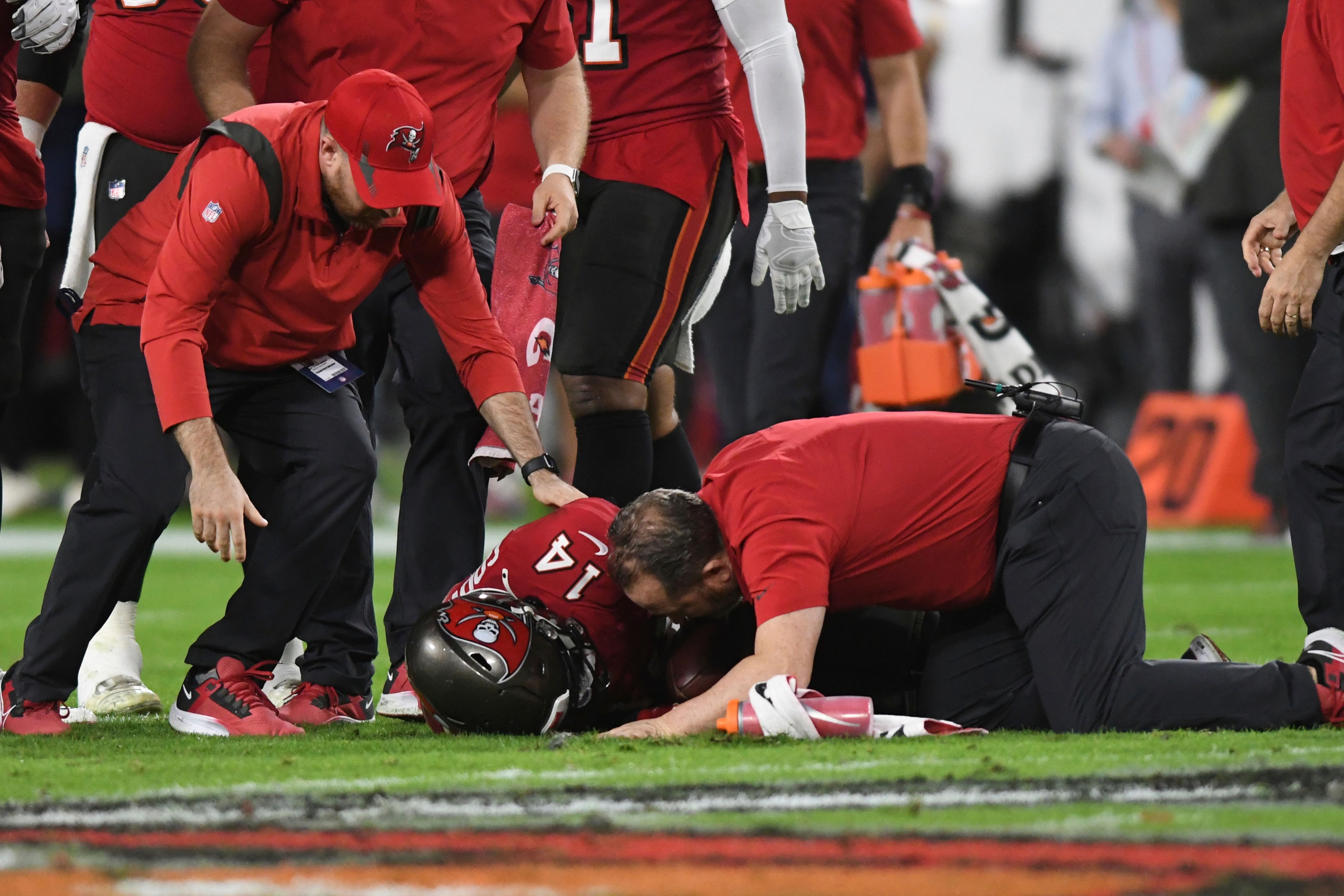 Trainers elp Tampa Bay Buccaneers wide receiver Chris Godwin (14) after he was shaken up during the first half of an NFL football game against the New Orleans Saints Sunday, Dec. 19, 2021, in Tampa, Fla. (AP Photo/Jason Behnken) Trainers elp Tampa Bay Buccaneers wide receiver Chris Godwin (14) after he was shaken up during the first half of an NFL football game against the New Orleans Saints Sunday, Dec. 19, 2021, in Tampa, Fla. (AP Photo/Jason Behnken)
