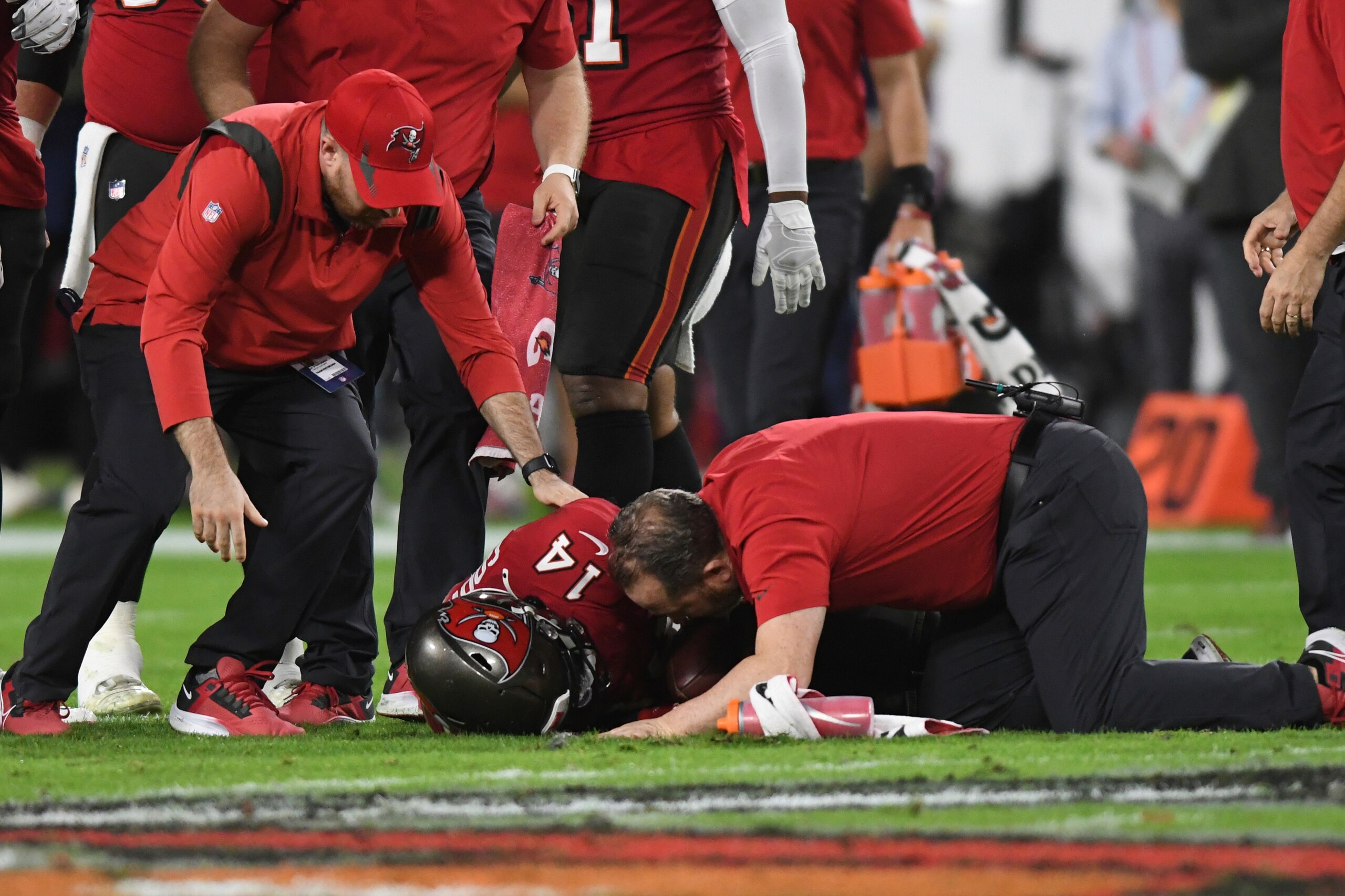 Trainers elp Tampa Bay Buccaneers wide receiver Chris Godwin (14) after he was shaken up during the first half of an NFL football game against the New Orleans Saints Sunday, Dec. 19, 2021, in Tampa, Fla. (AP Photo/Jason Behnken)
