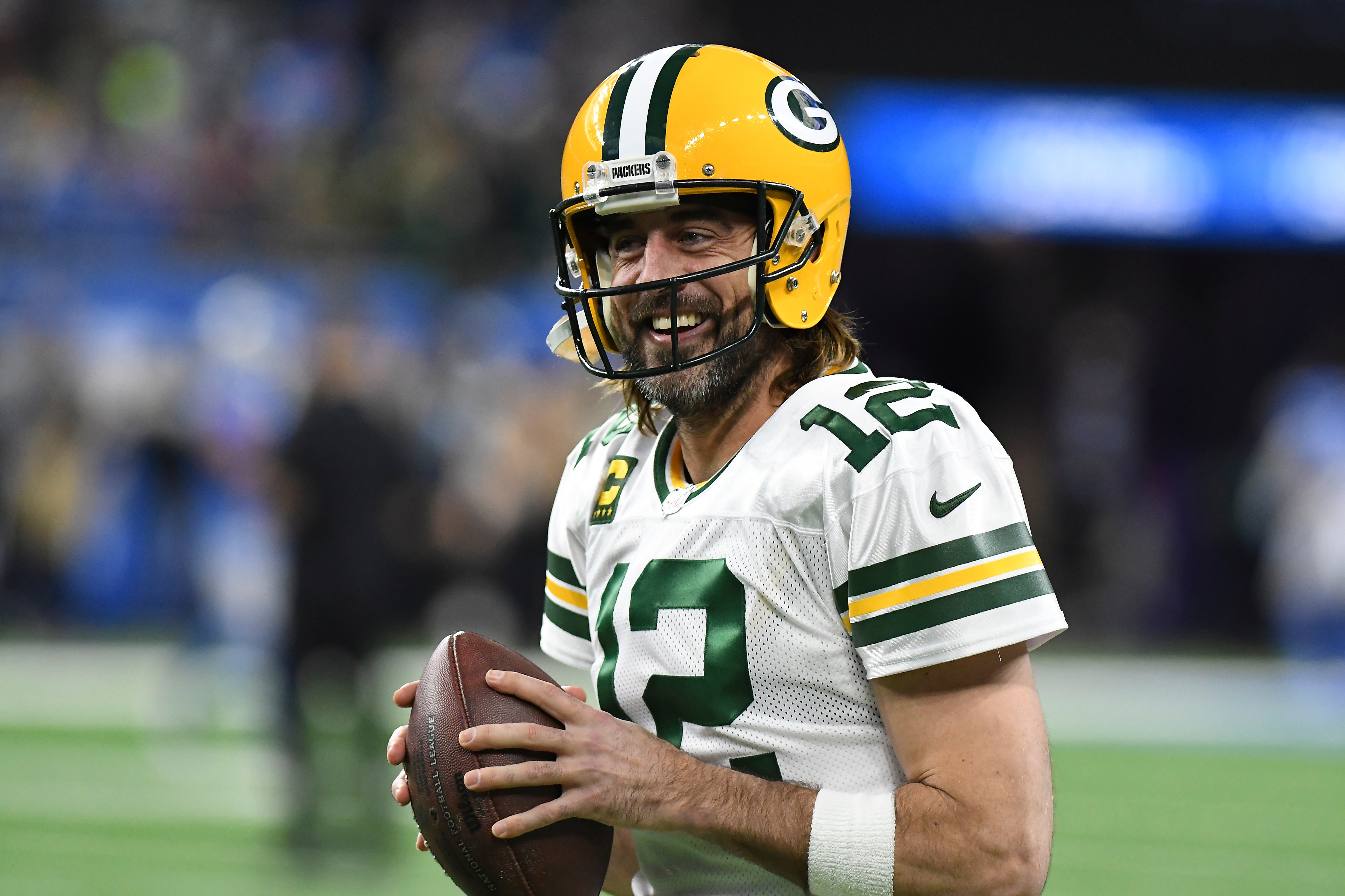 FILE - Green Bay Packers quarterback Aaron Rodgers smiles during pregame of an NFL football game against the Detroit Lions, Sunday, Jan. 9, 2022, in Detroit. Aaron Rodgers is planning to come back to the Green Bay Packers for an 18th season, a move that keeps the reigning MVP off the trade market and answers the question that had dominated NFL offseason discussions. (AP Photo/Lon Horwedel, File) FILE - Green Bay Packers quarterback Aaron Rodgers smiles during pregame of an NFL football game against the Detroit Lions, Sunday, Jan. 9, 2022, in Detroit. Aaron Rodgers is planning to come back to the Green Bay Packers for an 18th season, a move that keeps the reigning MVP off the trade market and answers the question that had dominated NFL offseason discussions. (AP Photo/Lon Horwedel, File)