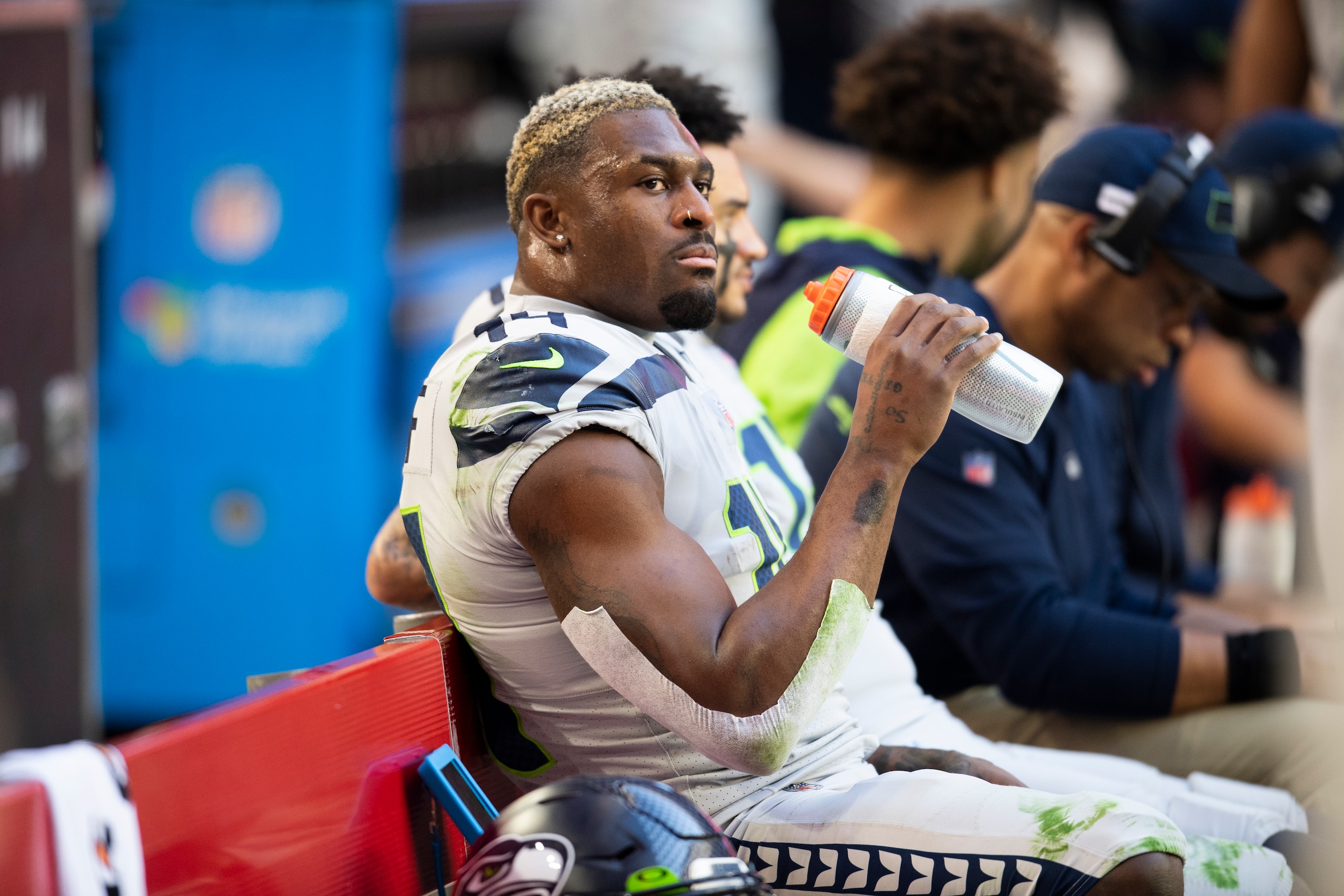 Seattle Seahawks wide receiver DK Metcalf (14) with his helmet off takes a drink on the sideline while playing the Arizona Cardinals during an NFL Professional Football Game Sunday, Jan. 9, 2022, in Phoenix. (AP Photo/John McCoy)