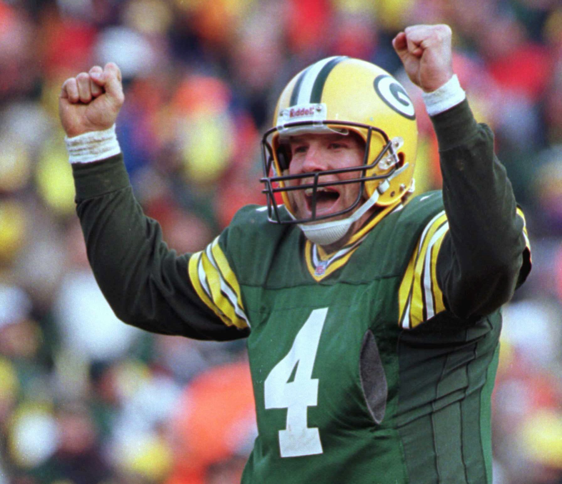 FILE - In this Sunday, Jan. 12, 1997, file photo, Green Bay Packers quarterback Brett Favre celebrates in the fourth quarter of a 30-13 win against the Carolina Panthers in the NFC Championship game at Lambeau Field in Green Bay, Wis. The Packers have reached another NFC championship game, finally returning it to Lambeau Field. The Packers will play the Tampa Bay Buccaneers on Sunday, Jan. 24, 2021.(AP Photo/Mark Duncan, File)