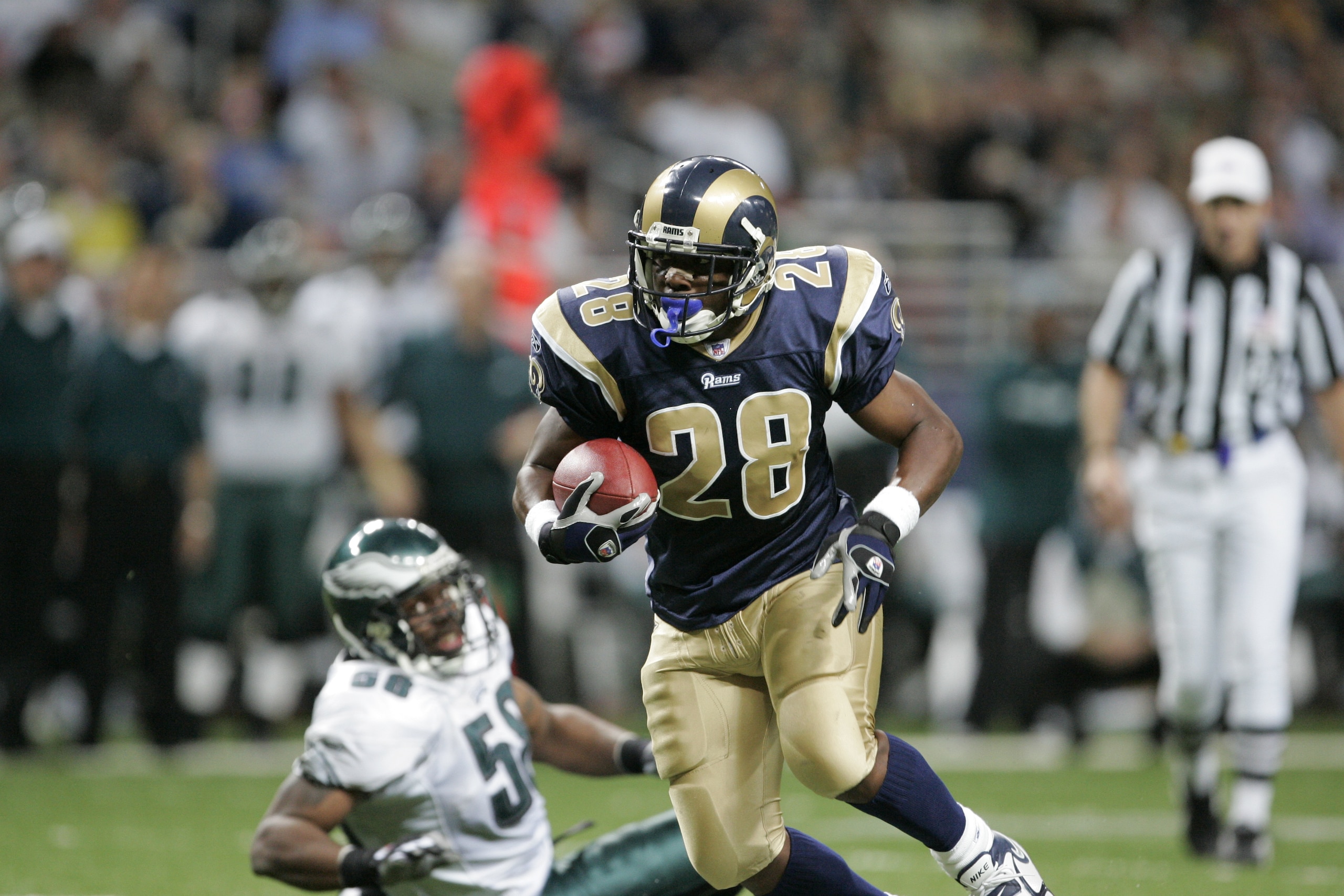 ST. LOUIS - DECEMBER 18: Running back Marshall Faulk #28 of the St. Louis Rams runs with the ball during the game against the Philadelphia Eagles on December 18, 2005 at Edward Jones Dome in St. Louis, Missouri. The Philadelphia Eagles defeated the St. Louis Rams 17-16. (Photo by Drew Hallowell/Getty Images)