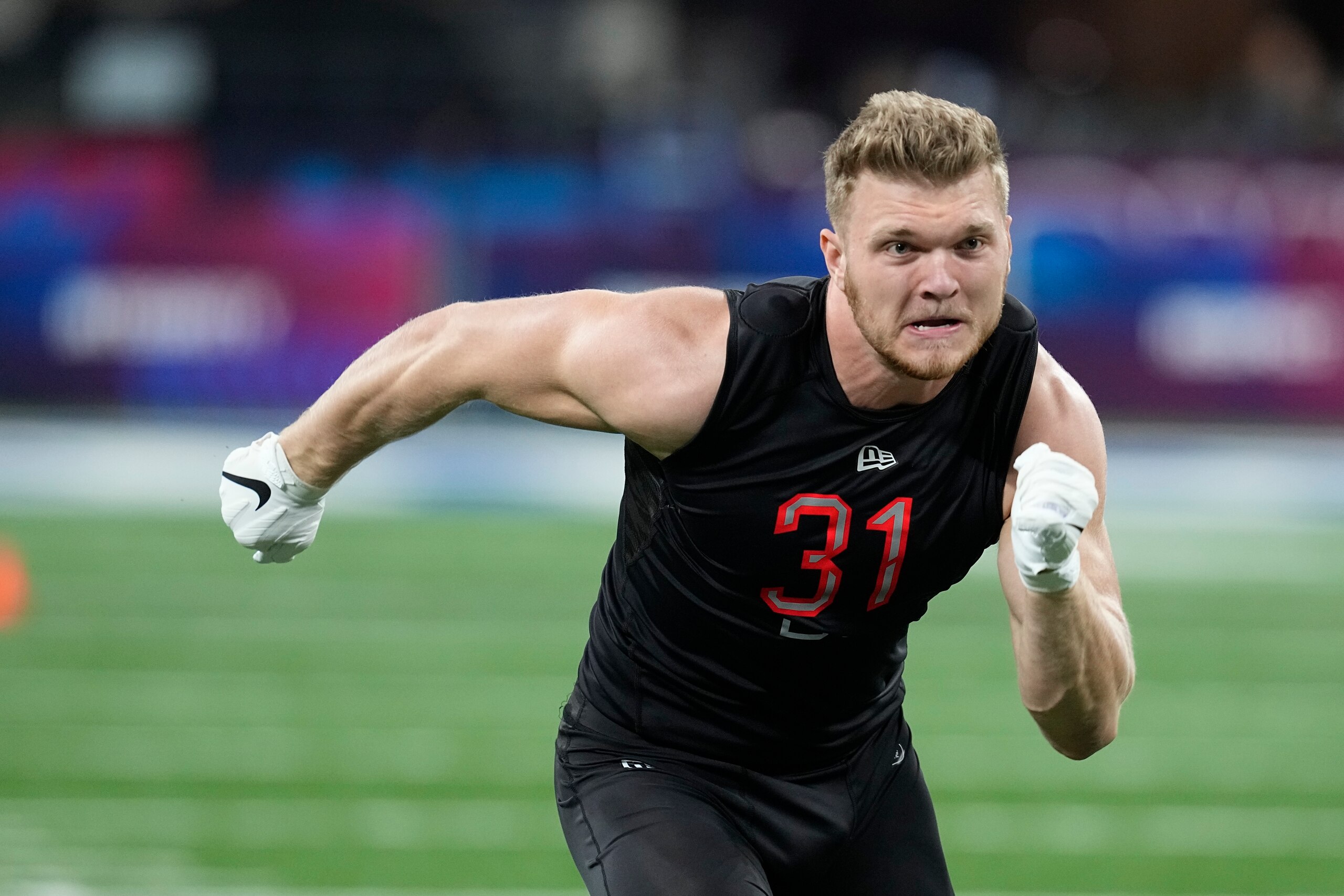 Michigan defensive lineman Aidan Hutchinson runs a drill during the NFL football scouting combine, Saturday, March 5, 2022, in Indianapolis. (AP Photo/Darron Cummings)