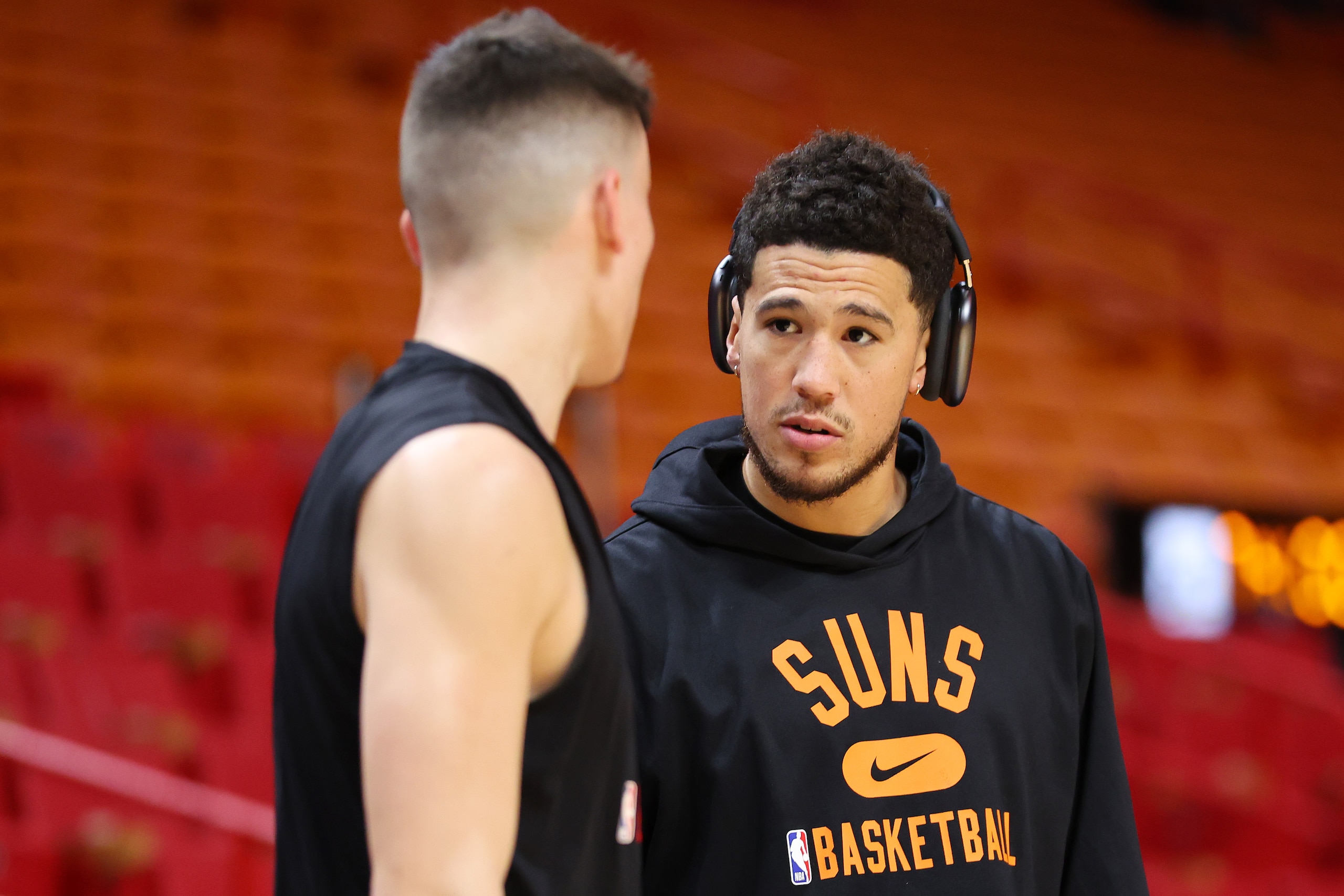 MIAMI, FLORIDA - MARCH 09: Tyler Herro #14 of the Miami Heat and Devin Booker #1 of the Phoenix Suns talk prior to the game at FTX Arena on March 09, 2022 in Miami, Florida. NOTE TO USER: User expressly acknowledges and agrees that, by downloading and or using this photograph, User is consenting to the terms and conditions of the Getty Images License Agreement. (Photo by Michael Reaves/Getty Images)