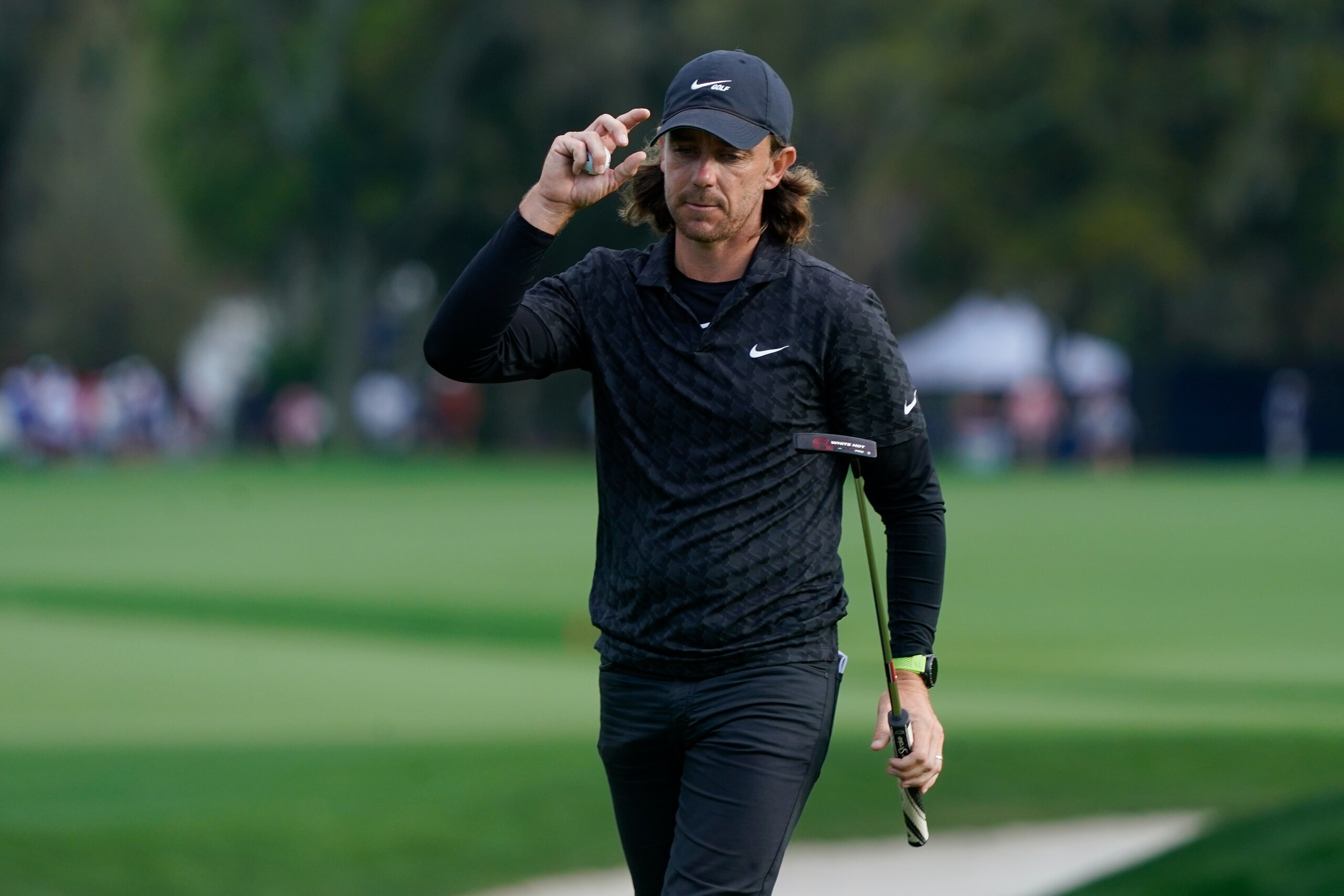 Tommy Fleetwood, of England, tips his cap to the crowd after finishing the 9th hole during the first round of play in The Players Championship golf tournament Thursday, March 10, 2022, in Ponte Vedra Beach, Fla. (AP Photo/Lynne Sladky)