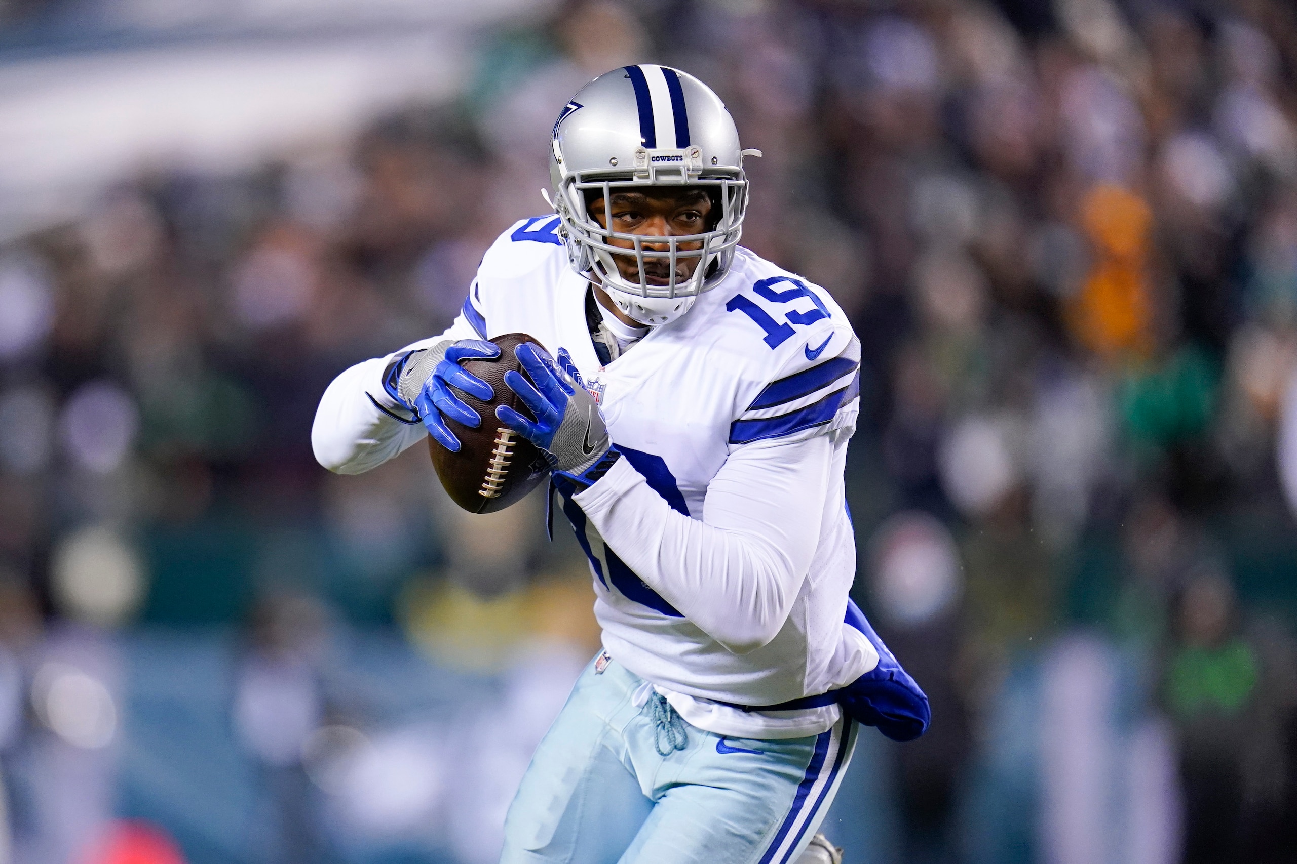 Dallas Cowboys wide receiver Amari Cooper runs with the ball after making a catch against the Philadelphia Eagles during the first half of an NFL football game between the Philadelphia Eagles and the Dallas Cowboys, Monday, Jan. 10, 2022, in Philadelphia. The Cowboys won 51-26. (AP Photo/Julio Cortez)