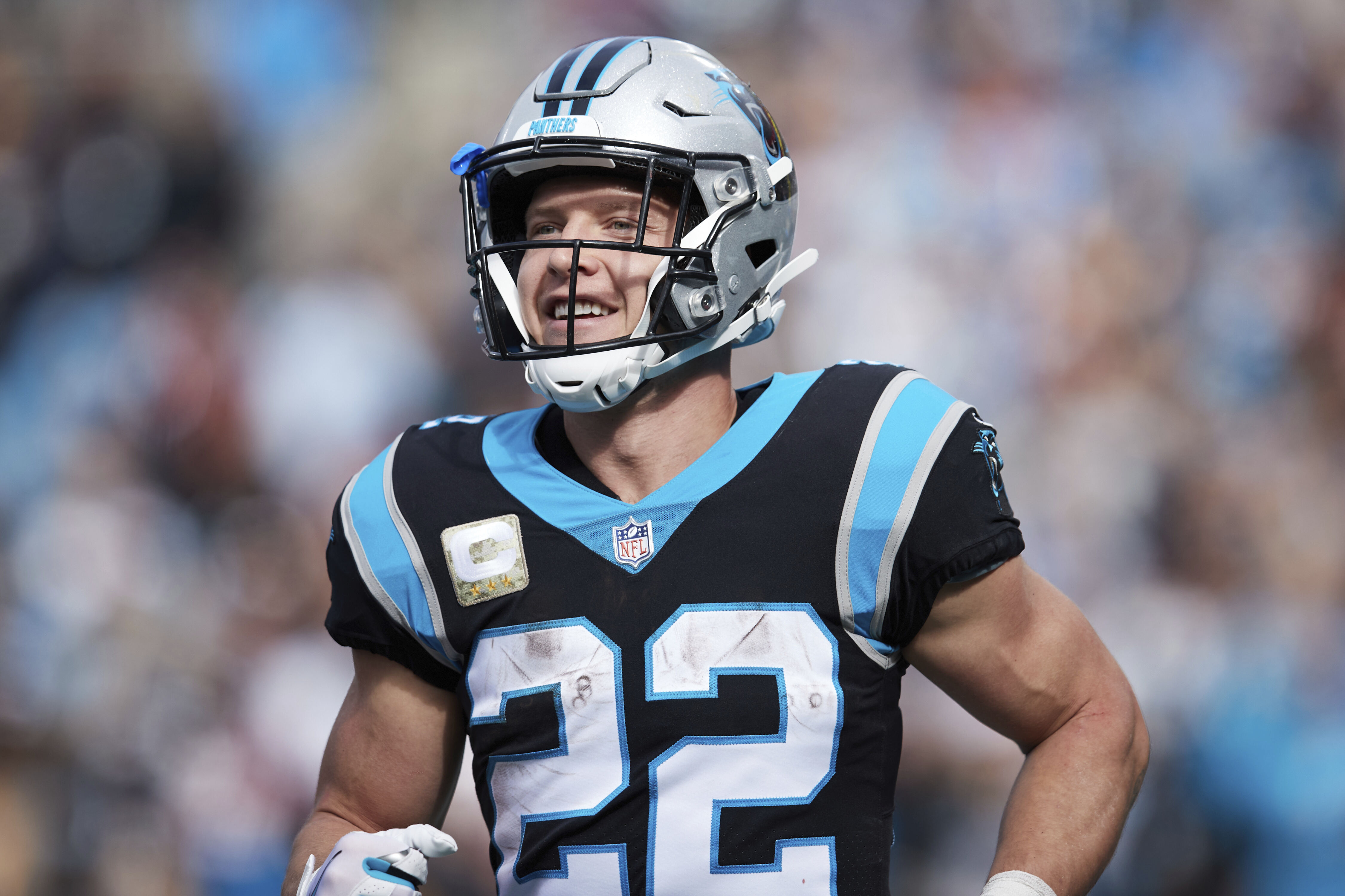 Carolina Panthers running back Christian McCaffrey (22) smiles after a touchdown during an NFL football game against the Washington Football Team, Sunday, Nov. 21, 2021, in Charlotte, N.C. (AP Photo/Brian Westerholt)