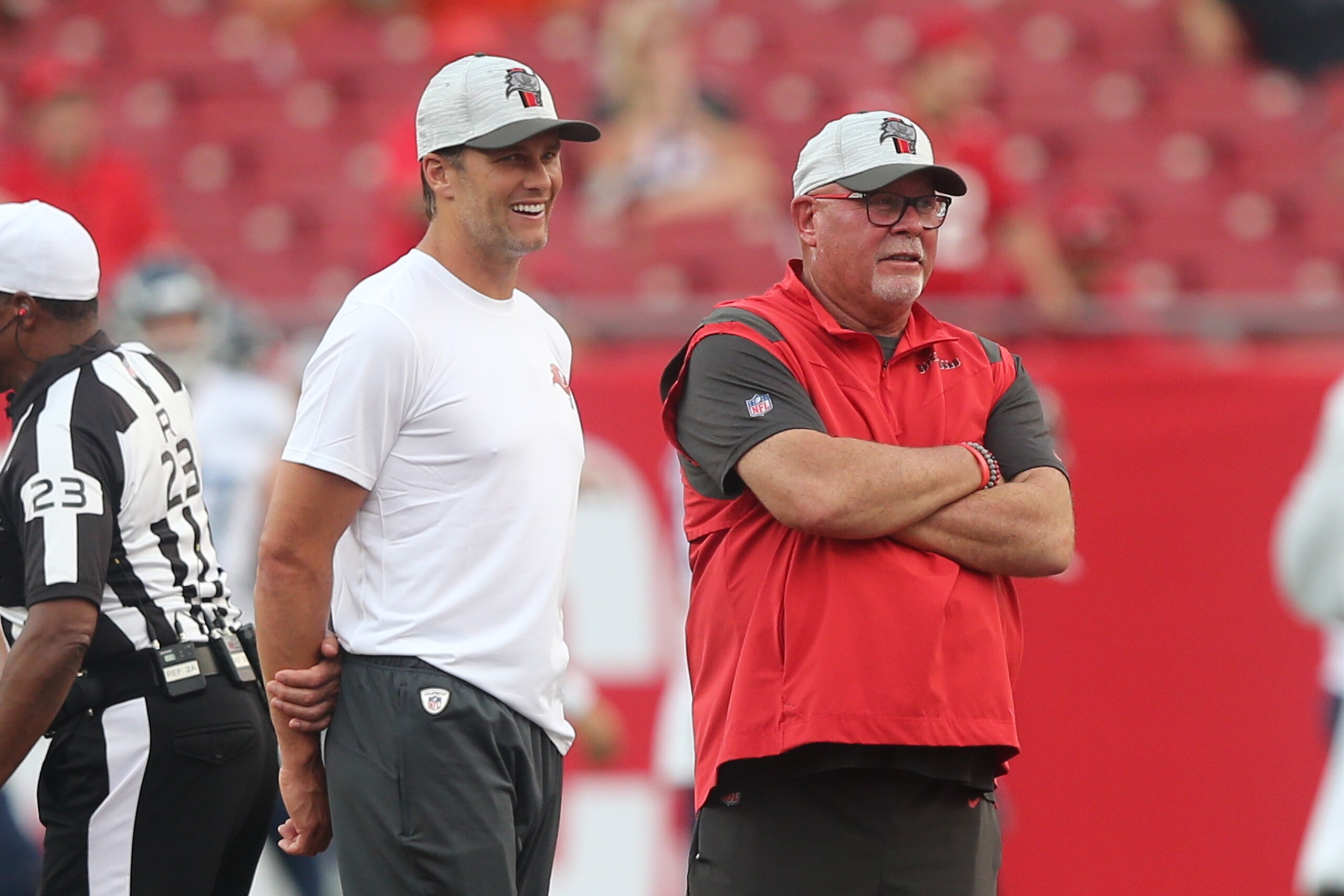 TAMPA, FL - AUGUST 21: Bucs QB Tom Brady (12) and Buccaneers Head Coach Bruce Arians watch the team warm up before the preseason game between the Tennessee Titans and the Tampa Bay Buccaneers on August 21, 2021 at Raymond James Stadium in Tampa, Florida. (Photo by Cliff Welch/Icon Sportswire via Getty Images)