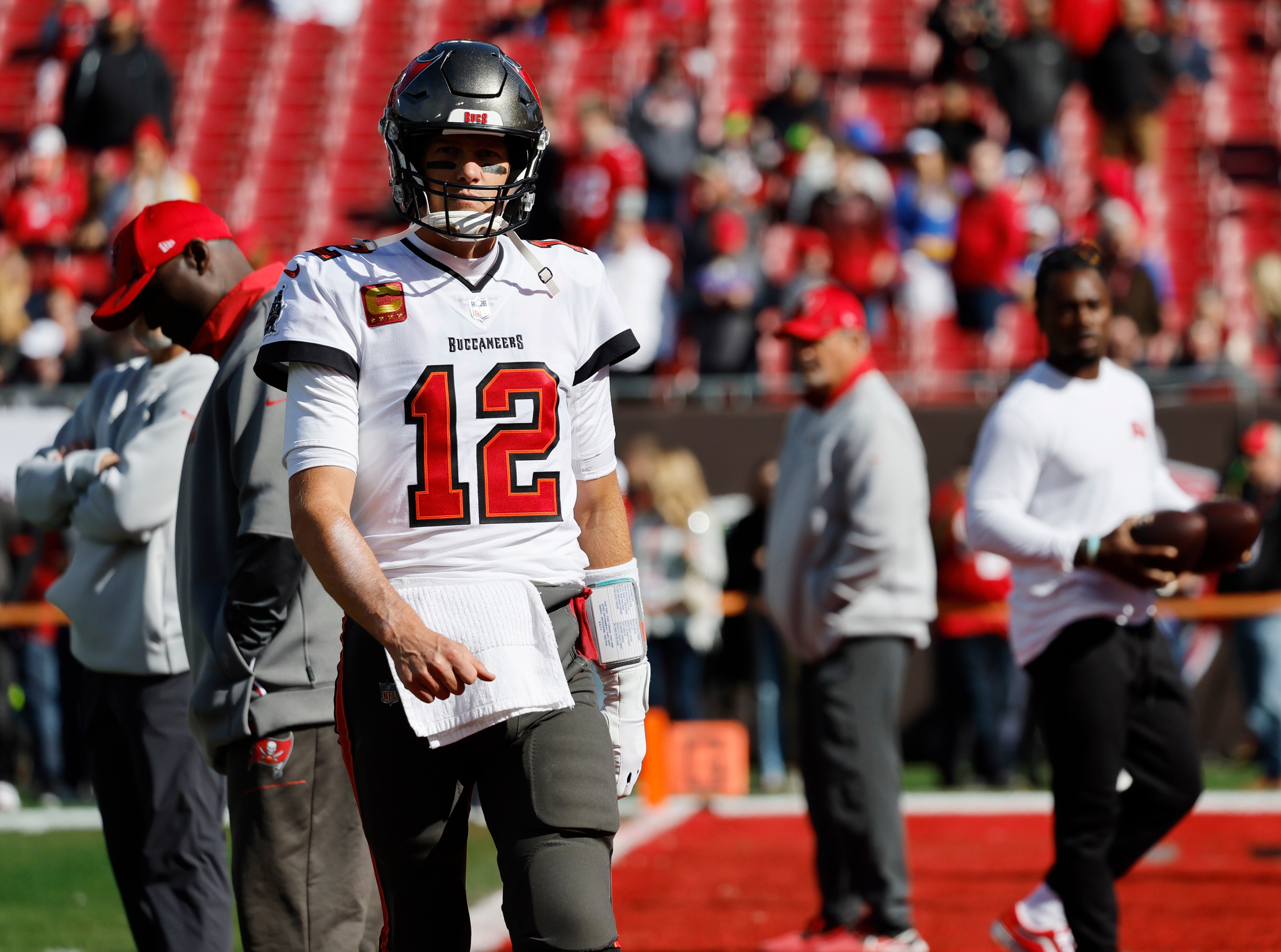 TAMPA BAY, FL- JANUARY 23, 2022: Tampa Bay Buccaneers quarterback Tom Brady (12) walks to the sidelines before the start of the game against the Rams in the NFC Divisional game  at Raymond James Stadium on January 23, 2022 in Tampa Bay, Florida. He announced  today that he is retiring after 22 years in the NFL.(Gina Ferazzi / Los Angeles Times via Getty Images)
