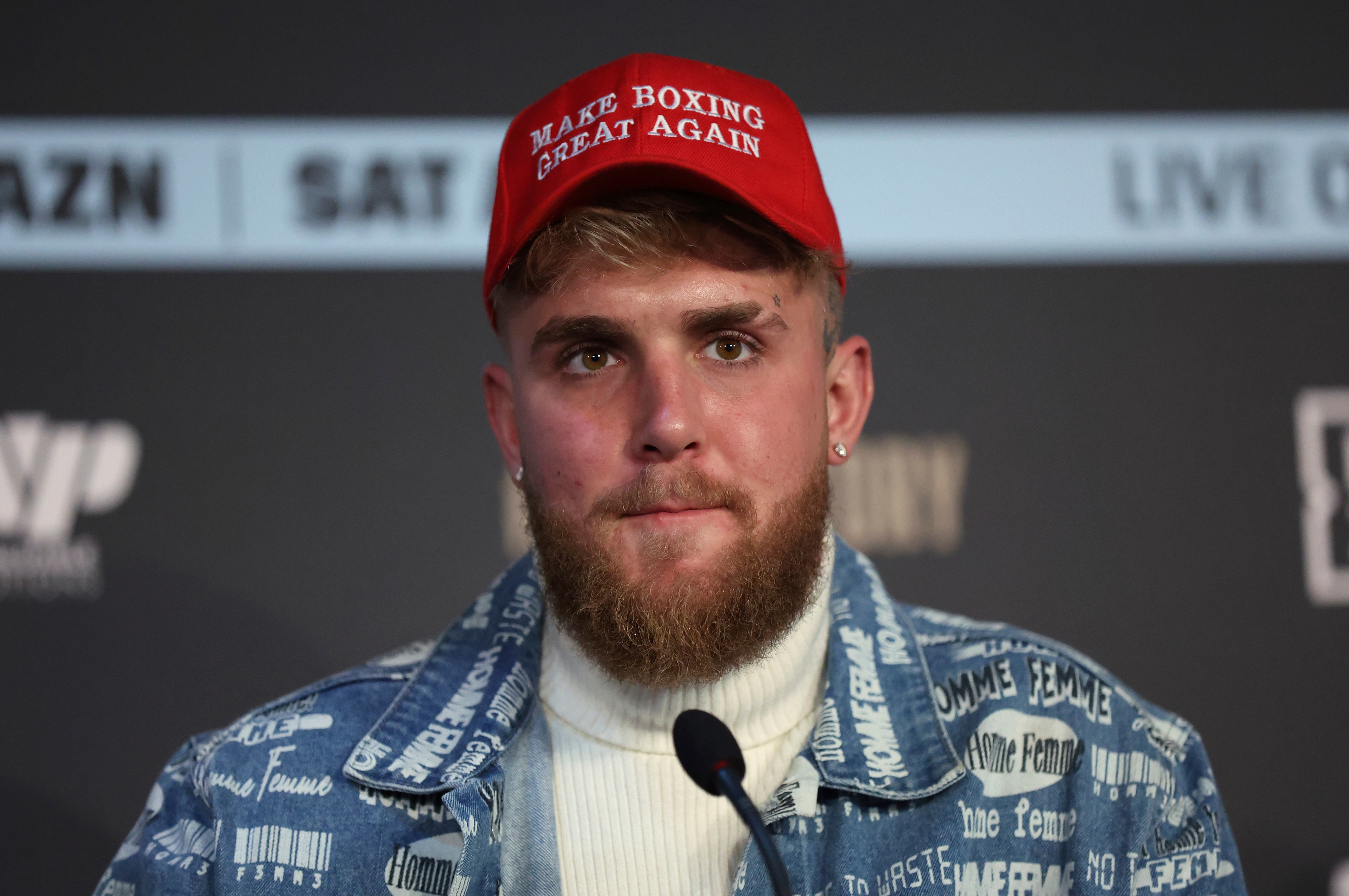 Boxing co-promoter Jake Paul wears a "Make Boxing Great Again" cap during a press conference at the Leadenhall Building in London, on the second leg of the press tour to promote the upcoming fight between Ireland's Katie Taylor and Puerto Rico's Amanda Serrano, Monday, Feb. 7, 2022. In one of the biggest events in women's boxing history Katie Taylor will defend her lightweight titles against Amanda Serrano on April 30 in what organizers say will be the first women's boxing match to headline Madison Square Garden. (AP Photo/Ian Walton)