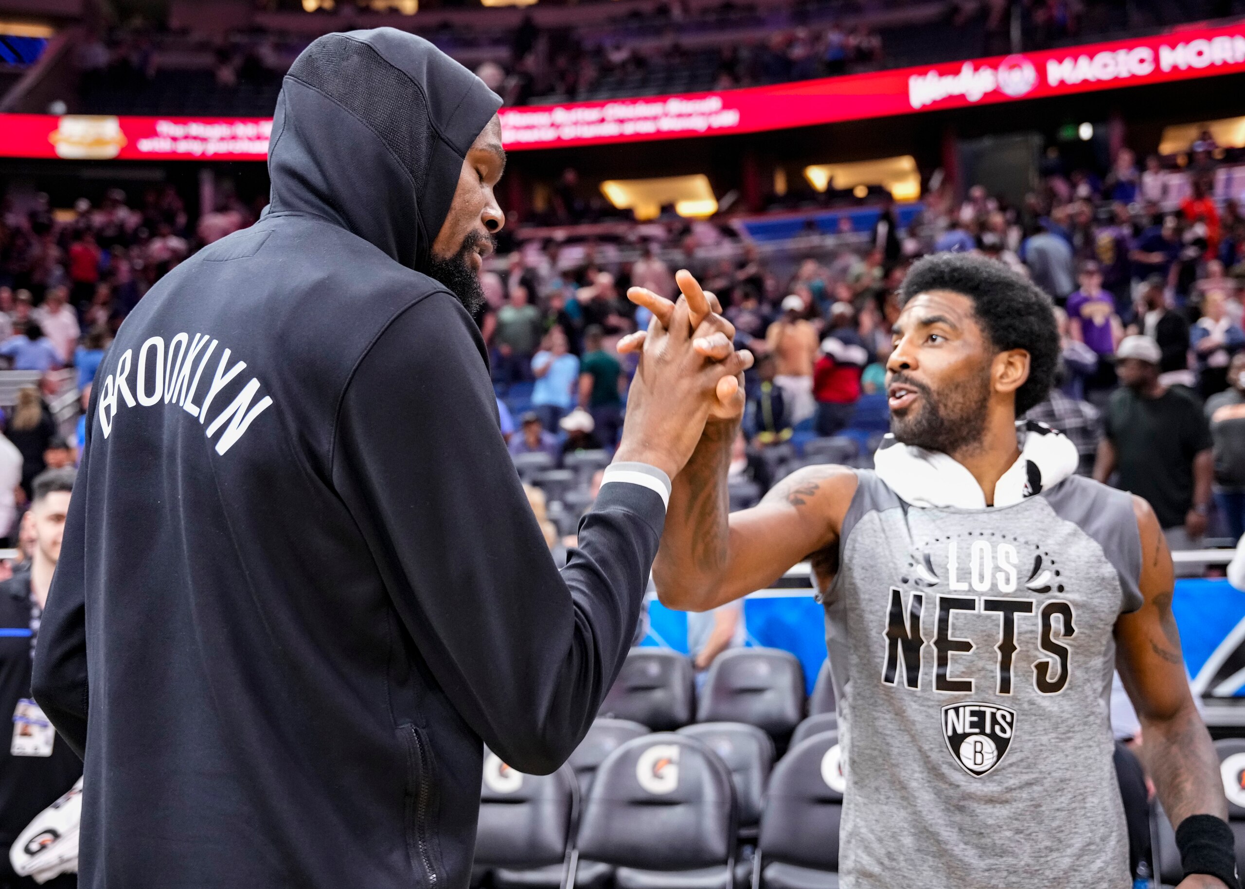 ORLANDO, FLORIDA - MARCH 15: Kyrie Irving #11 of the Brooklyn Nets celebrates with Kevin Durant #7 after scoring a career high and franchise record 60 points in beating the Orlando Magic by score of 150-108 at Amway Center on March 15, 2022 in Orlando, Florida. NOTE TO USER: User expressly acknowledges and agrees that, by downloading and or using this photograph, User is consenting to the terms and conditions of the Getty Images License Agreement. (Photo by Mark Brown/Getty Images)