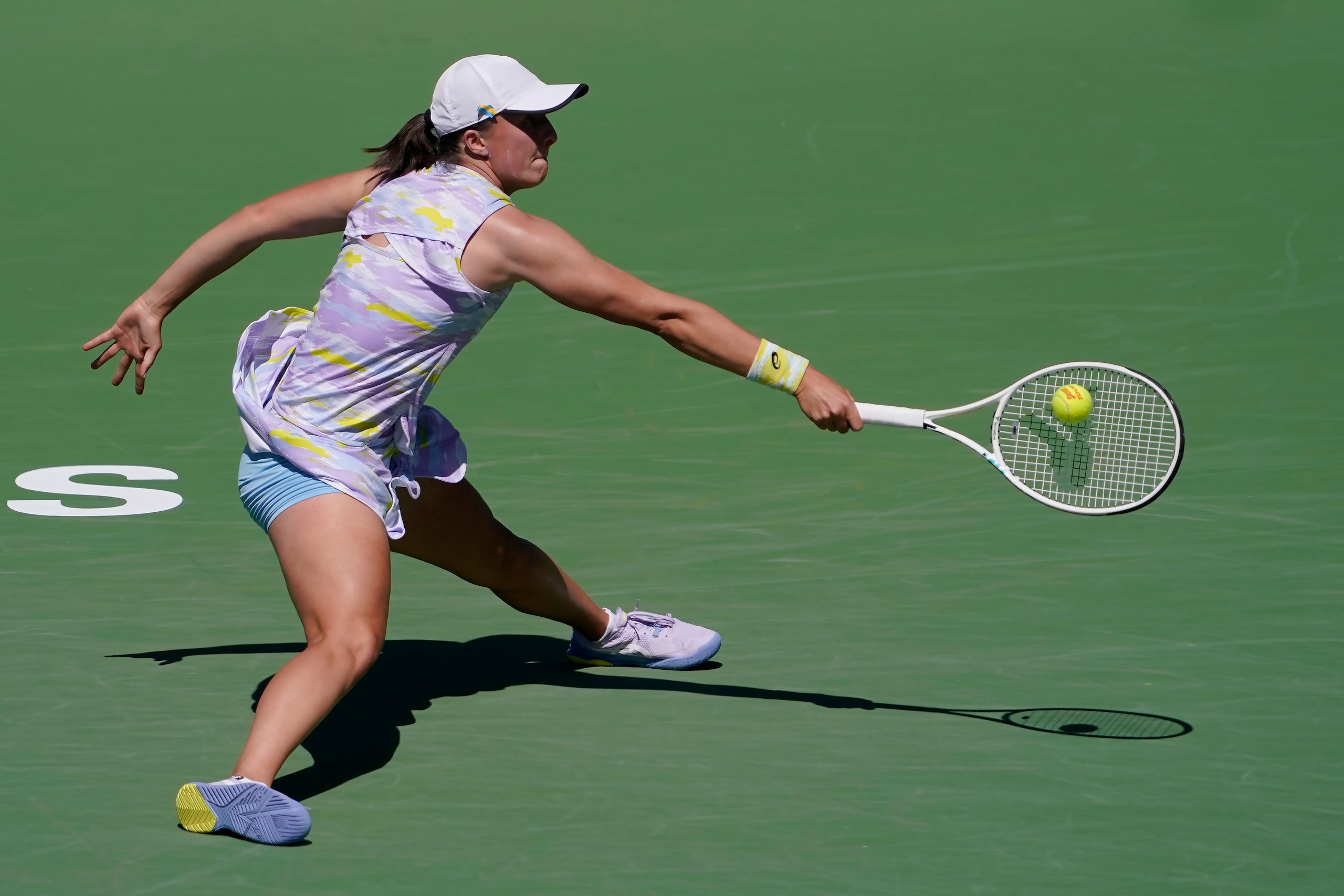 Iga Swiatek, of Poland, returns a shot against Angelique Kerber, of Germany, at the BNP Paribas Open tennis tournament Tuesday, March 15, 2022, in Indian Wells, Calif. (AP Photo/Mark J. Terrill)