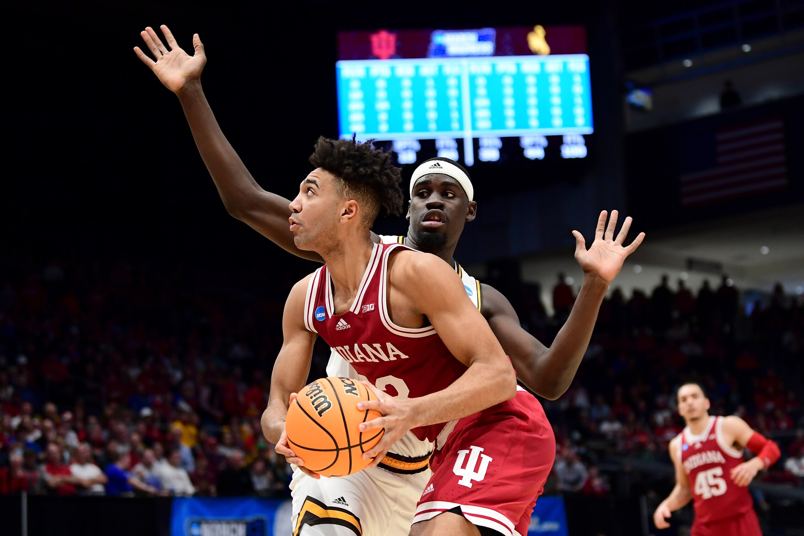 DAYTON, OHIO - MARCH 15: Trayce Jackson-Davis #23 of the Indiana Hoosiers drives past Graham Ike #33 of the Wyoming Cowboys during the second half in the First Four game of the 2022 NCAA Men's Basketball Tournament at UD Arena on March 15, 2022 in Dayton, Ohio. (Photo by Emilee Chinn/Getty Images)