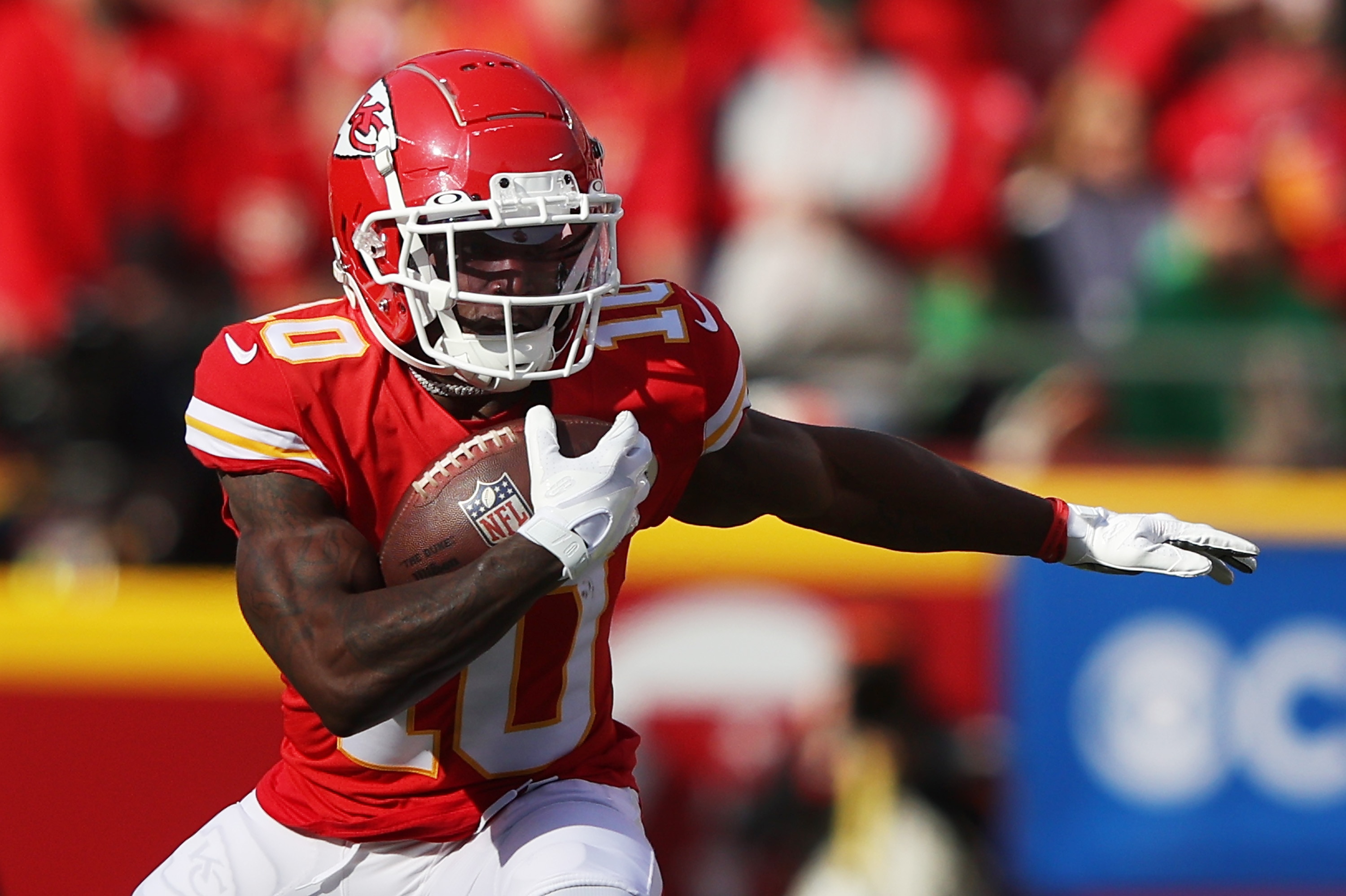 KANSAS CITY, MISSOURI - JANUARY 30: Wide receiver Tyreek Hill #10 of the Kansas City Chiefs carries the ball after catching a first quarter pass in the AFC Championship Game against the Cincinnati Bengals at Arrowhead Stadium on January 30, 2022 in Kansas City, Missouri. (Photo by Jamie Squire/Getty Images)