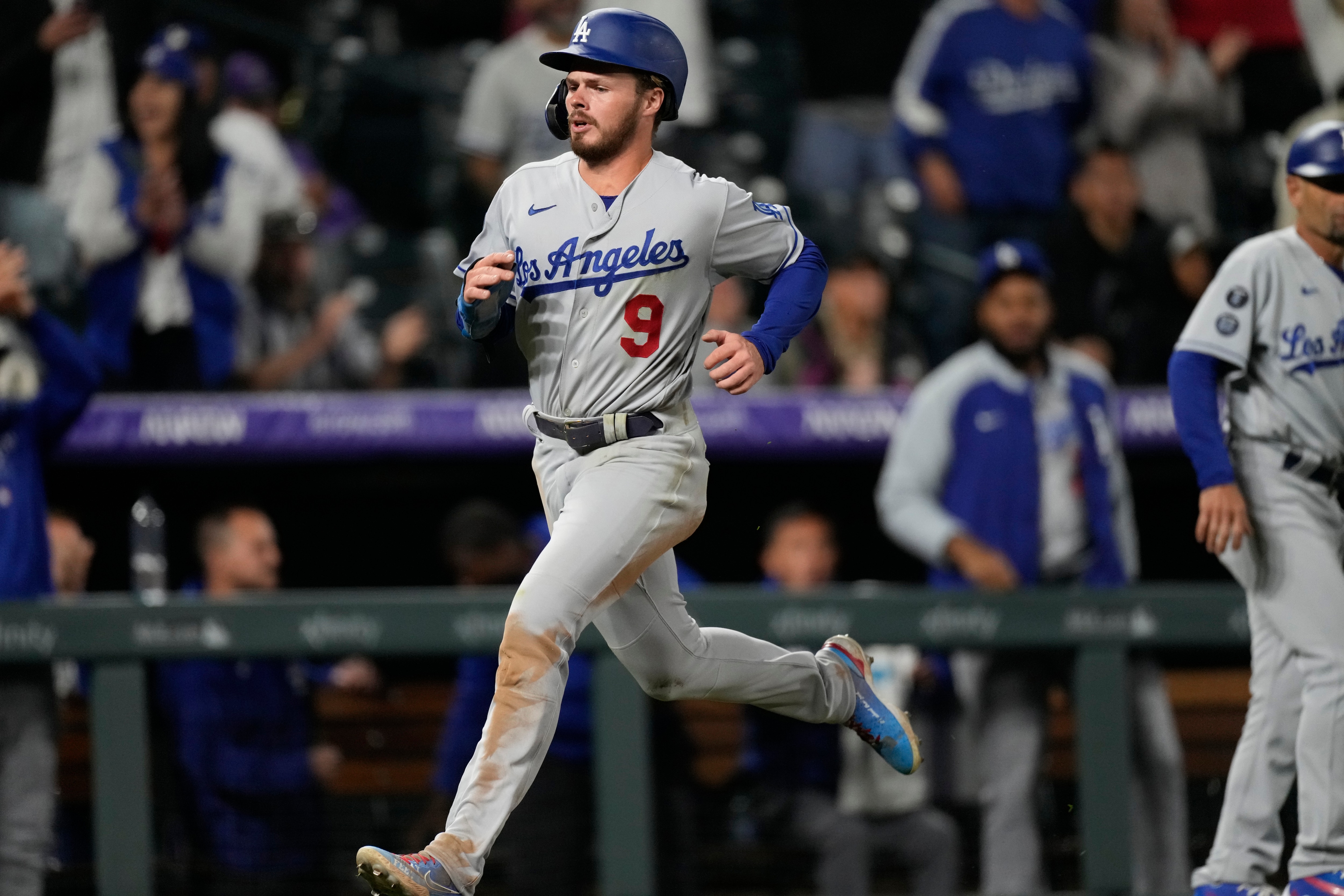 Los Angeles Dodgers' Gavin Lux scores on a single hit by pinch-hitter Albert Pujols off Colorado Rockies relief pitcher Jhoulys Chacin in the 10th inning of a baseball game Tuesday, Sept. 21, 2021, in Denver. The Dodgers won 5-4. (AP Photo/David Zalubowski)