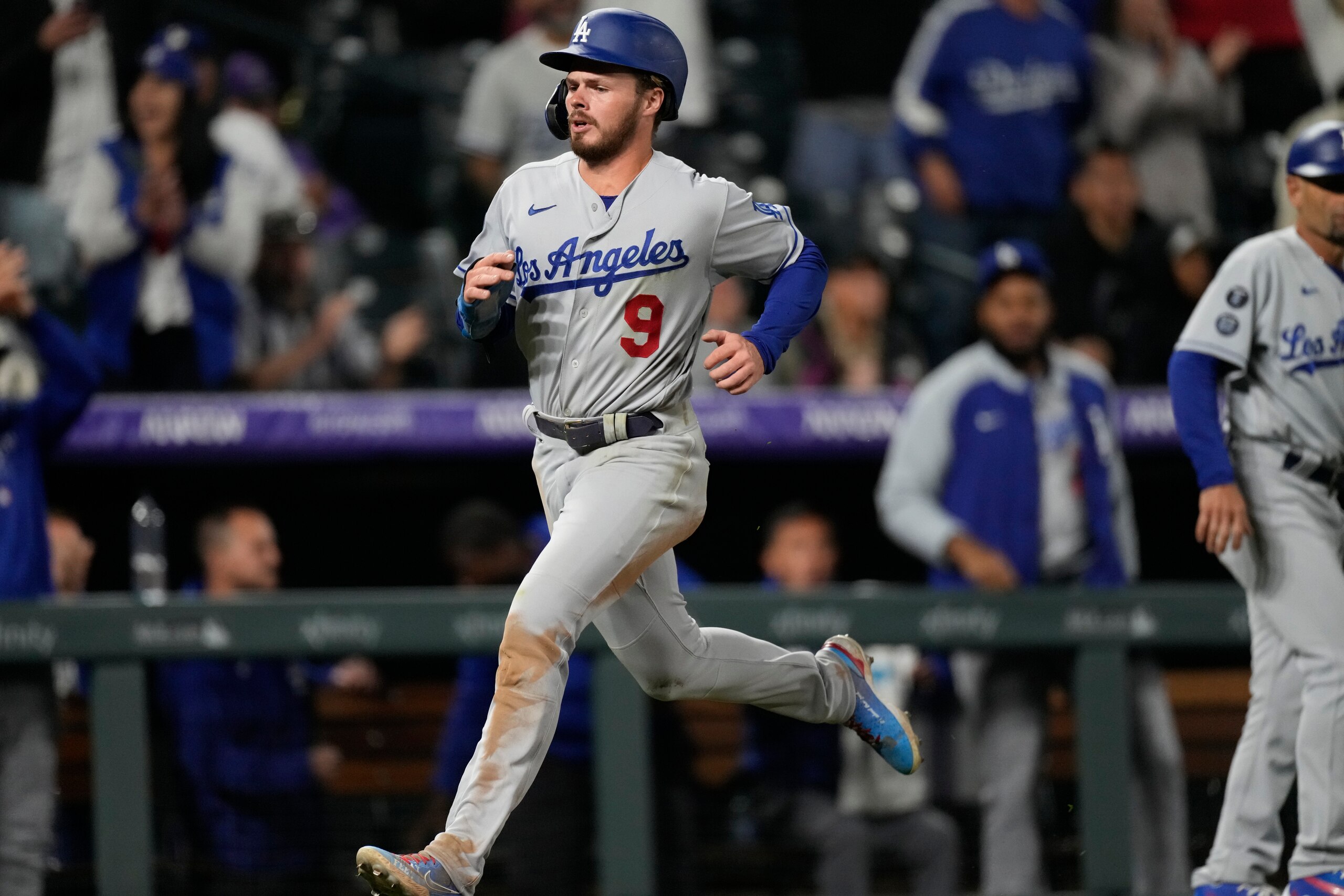 Los Angeles Dodgers' Gavin Lux scores on a single hit by pinch-hitter Albert Pujols off Colorado Rockies relief pitcher Jhoulys Chacin in the 10th inning of a baseball game Tuesday, Sept. 21, 2021, in Denver. The Dodgers won 5-4. (AP Photo/David Zalubowski)