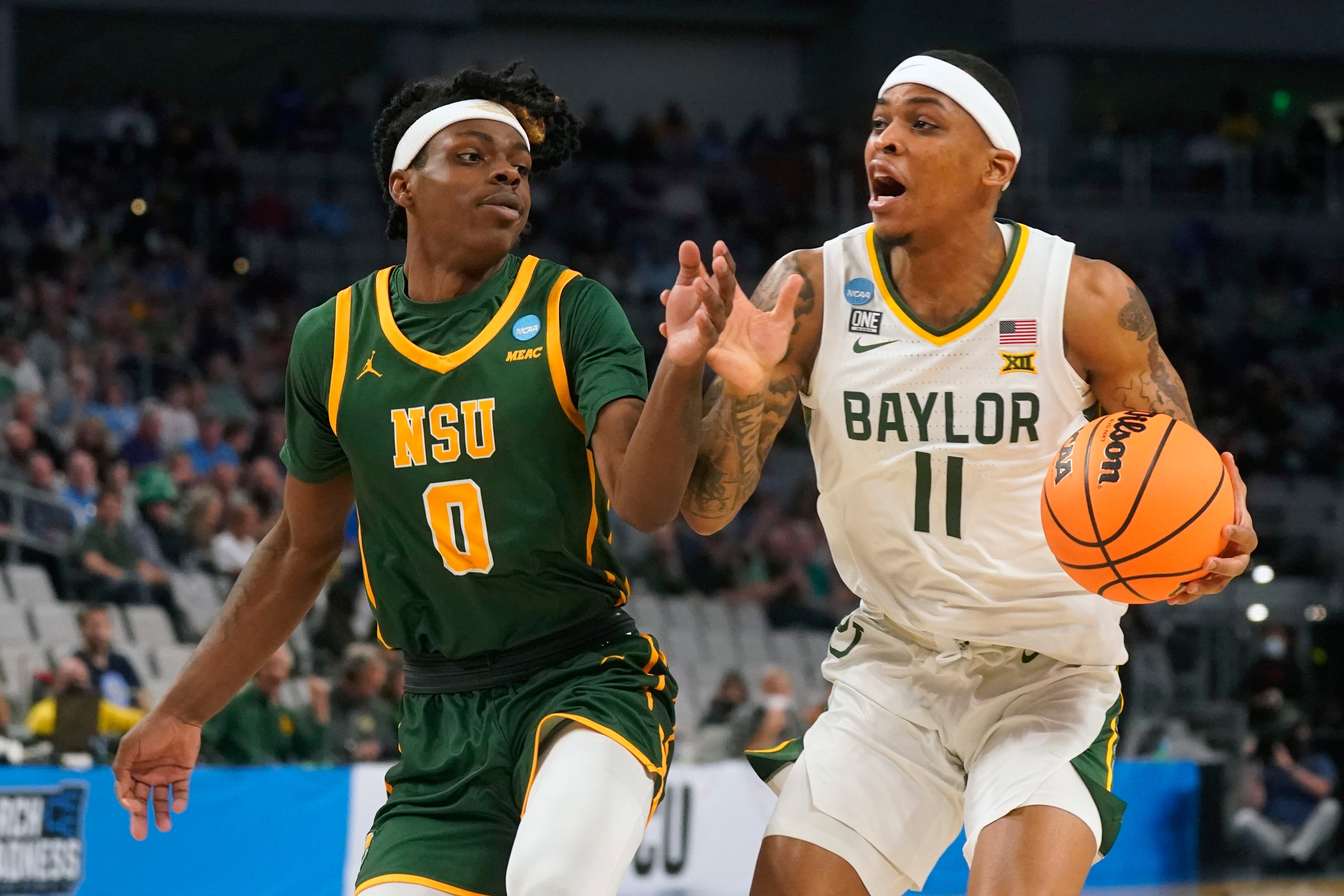 Baylor guard James Akinjo (11) drives against Norfolk State guard Christian Ings (0) during the first half of a college basketball game in the first round of the NCAA tournament in Fort Worth, Texas, Thursday, March 17, 2022. (AP Photo/LM Otero)