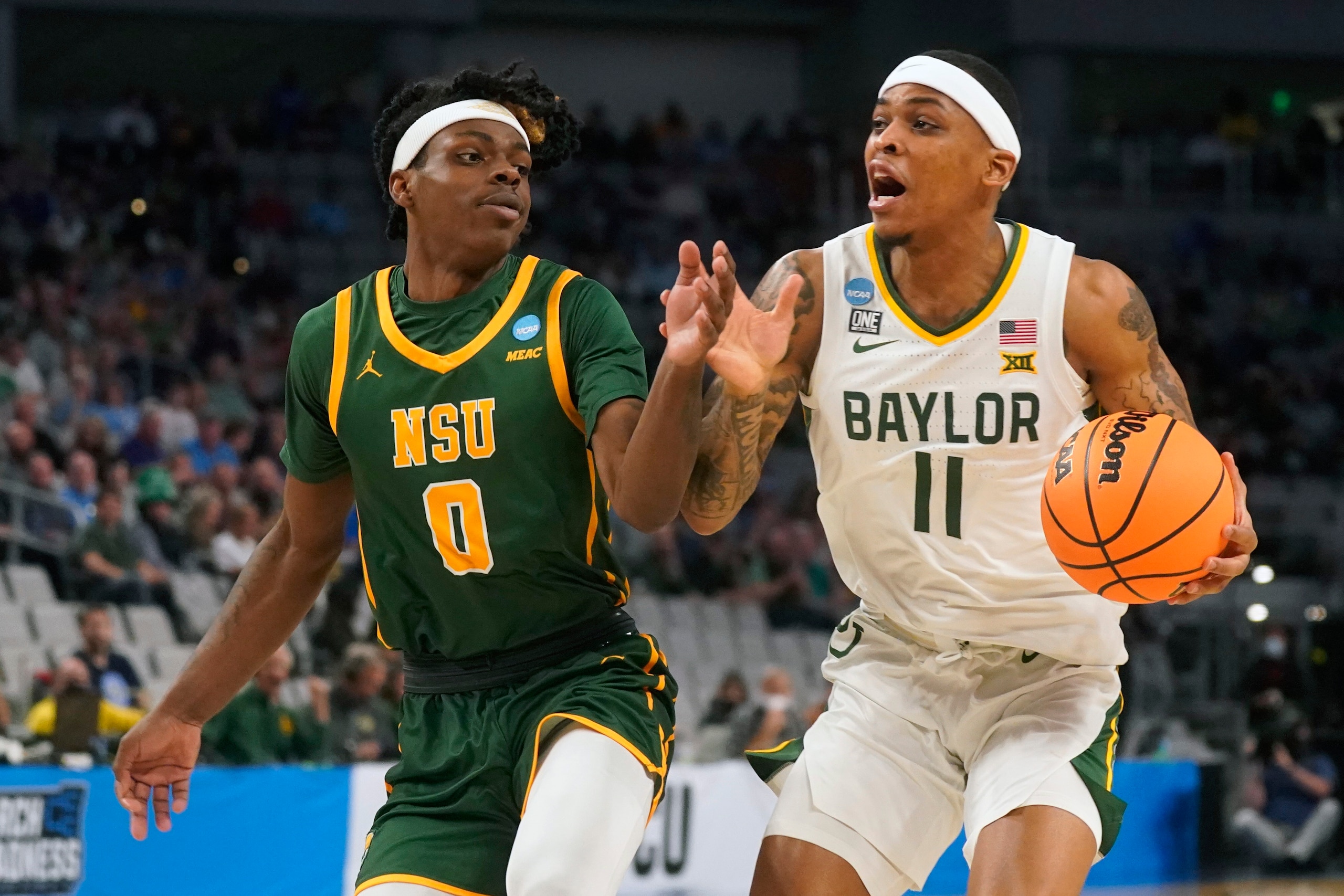 Baylor guard James Akinjo (11) drives against Norfolk State guard Christian Ings (0) during the first half of a college basketball game in the first round of the NCAA tournament in Fort Worth, Texas, Thursday, March 17, 2022. (AP Photo/LM Otero) Baylor guard James Akinjo (11) drives against Norfolk State guard Christian Ings (0) during the first half of a college basketball game in the first round of the NCAA tournament in Fort Worth, Texas, Thursday, March 17, 2022. (AP Photo/LM Otero)