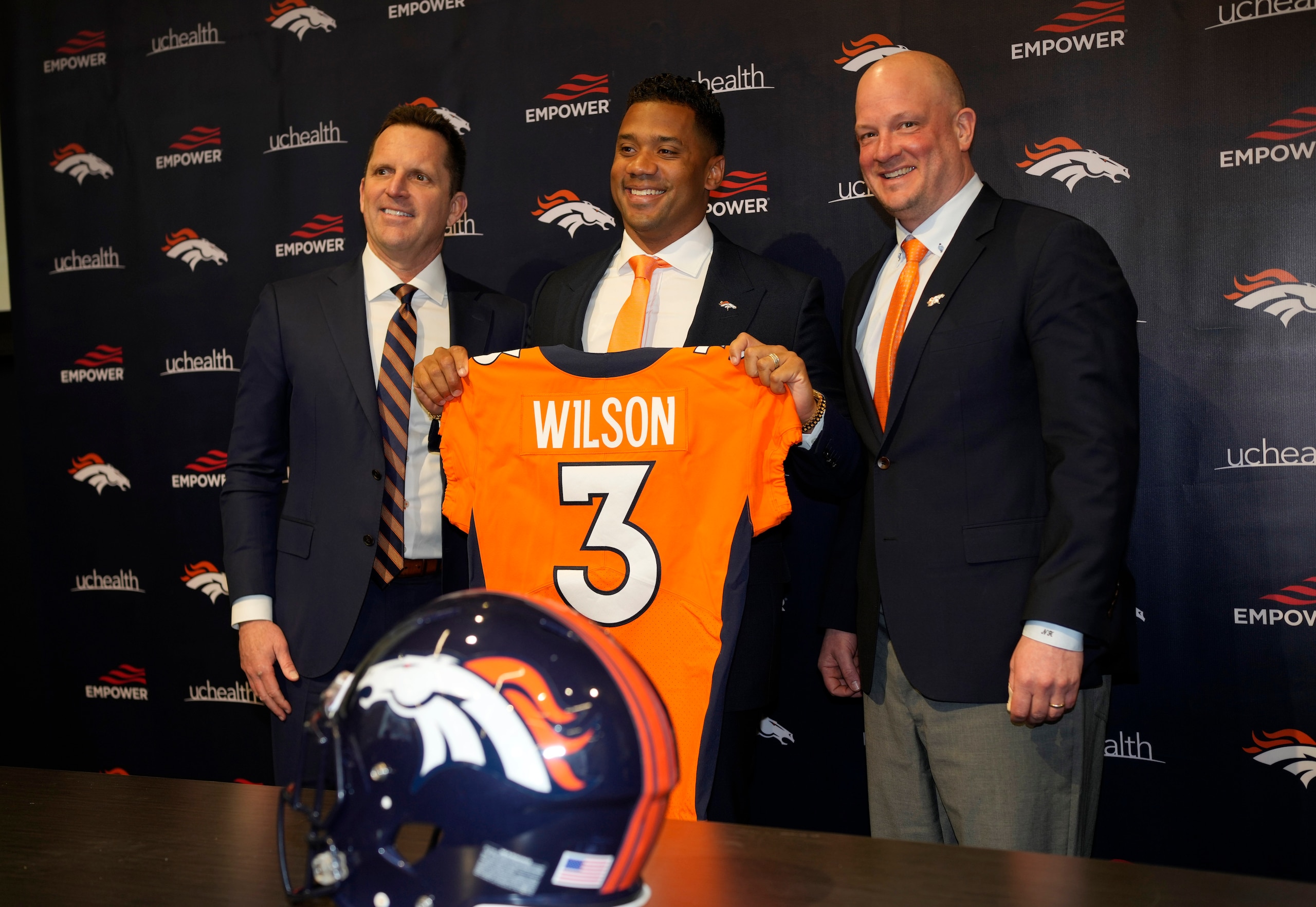 Denver Broncos new starting quarterback Russell Wilson, center, holds up his new jersey for a photograph with head coach Nathaniel Hackett, right, and general manager George Paton during a news conference Wednesday, March 16, 2022, at the team's headquarters in Englewood, Colo. (AP Photo/David Zalubowski) Denver Broncos new starting quarterback Russell Wilson, center, holds up his new jersey for a photograph with head coach Nathaniel Hackett, right, and general manager George Paton during a news conference Wednesday, March 16, 2022, at the team's headquarters in Englewood, Colo. (AP Photo/David Zalubowski)