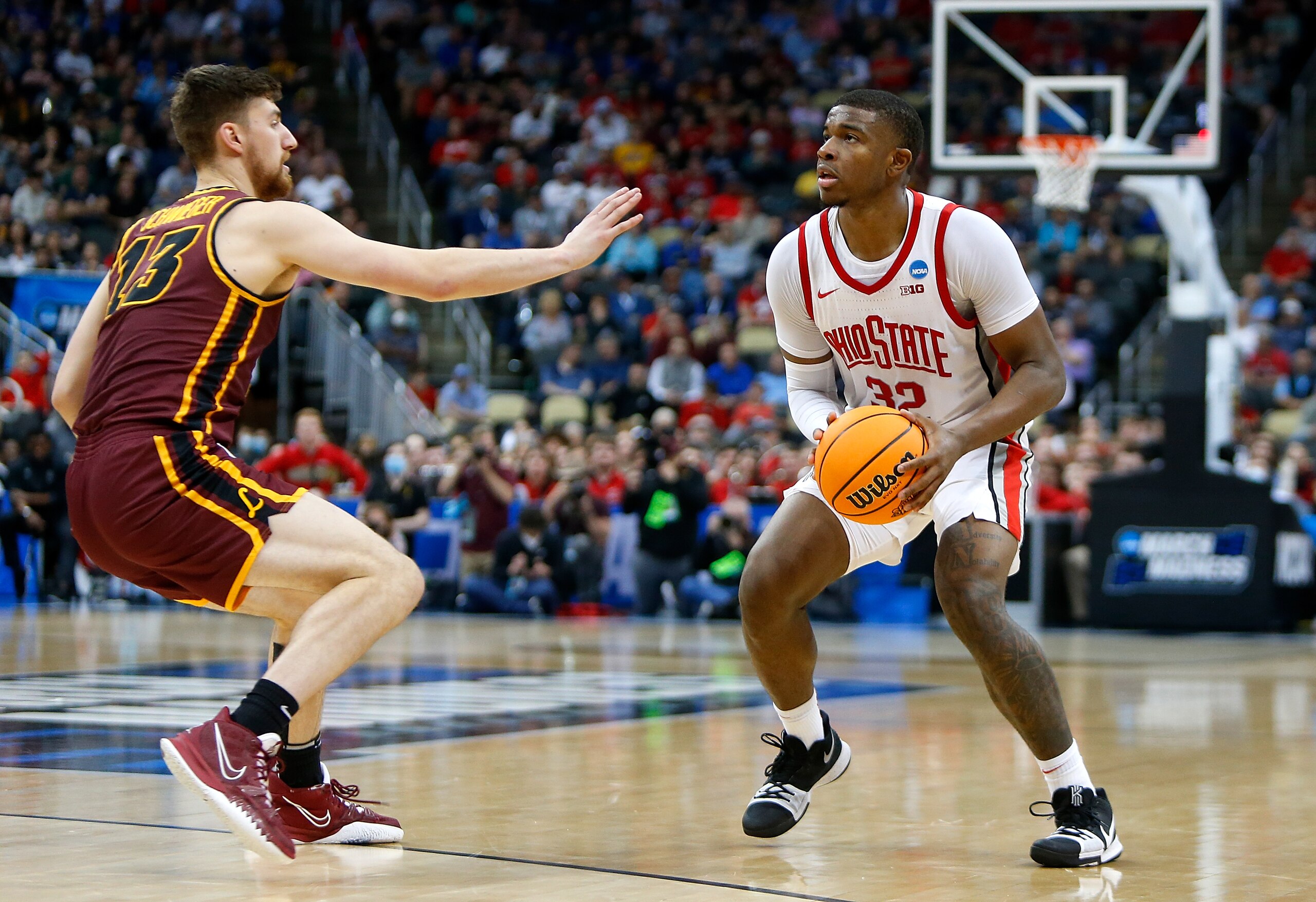 PITTSBURGH, PA - MARCH 18:  E.J. Liddell #32 of the Ohio State Buckeyes is defended by Ryan Schwieger #13 of the Loyola-Chicago Ramblers in the first half during the first round of the 2022 NCAA Men's Basketball Tournament held at PPG PAINTS Arena on March 18, 2022 in Pittsburgh, Pennsylvania. (Photo by Justin K. Aller/NCAA Photos via Getty Images)
