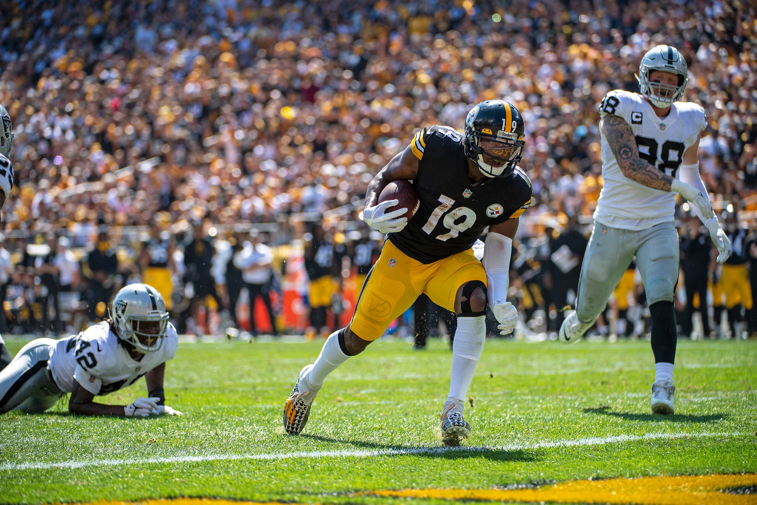 Pittsburgh Steelers wide receiver JuJu Smith-Schuster (19) rushes for a 3 yard touchdown in the first half during the first half of an NFL football game against the Las Vegas Raiders, Sunday, Sept. 19, 2021, in Pittsburgh. (AP Photo/Justin Berl) Pittsburgh Steelers wide receiver JuJu Smith-Schuster (19) rushes for a 3 yard touchdown in the first half during the first half of an NFL football game against the Las Vegas Raiders, Sunday, Sept. 19, 2021, in Pittsburgh. (AP Photo/Justin Berl)