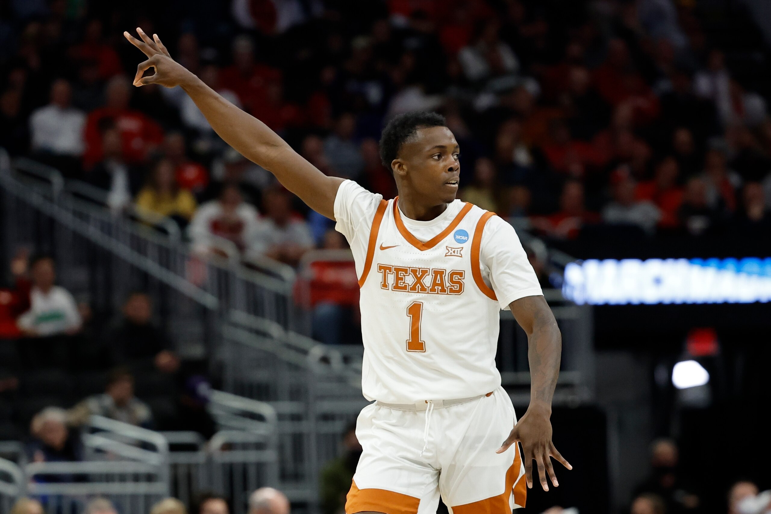 Texas's Andrew Jones recats after making a three-point basket during the first half of a first round NCAA college basketball tournament game against Virginia Tech Friday, March 18, 2022, in Milwaukee. (AP Photo/Jeffrey Phelps)