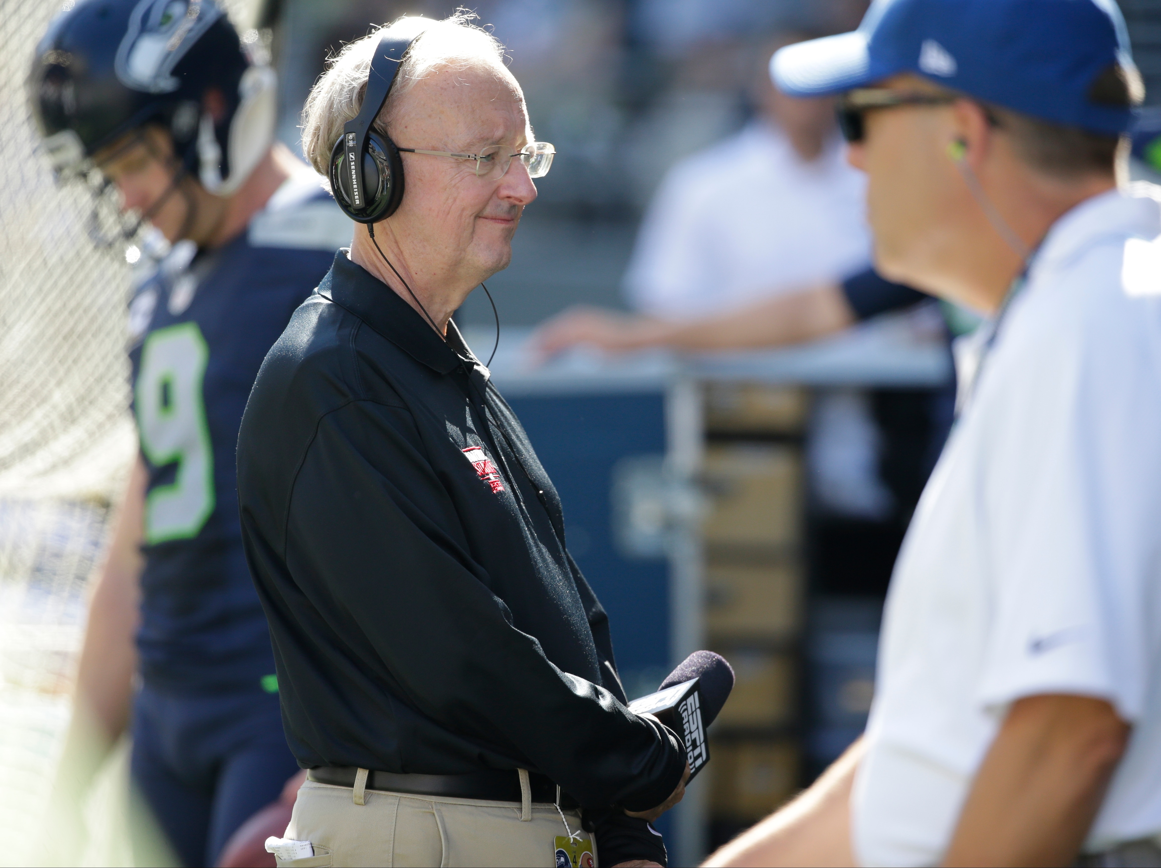 John "The Professor" Clayton, an NFL football writer and reporter for ESPN, stands on the sideline during an NFL football game between the Seattle Seahawks and the San Francisco 49ers, Sunday, Sept. 25, 2016, in Seattle. (AP Photo/Ted S. Warren)
