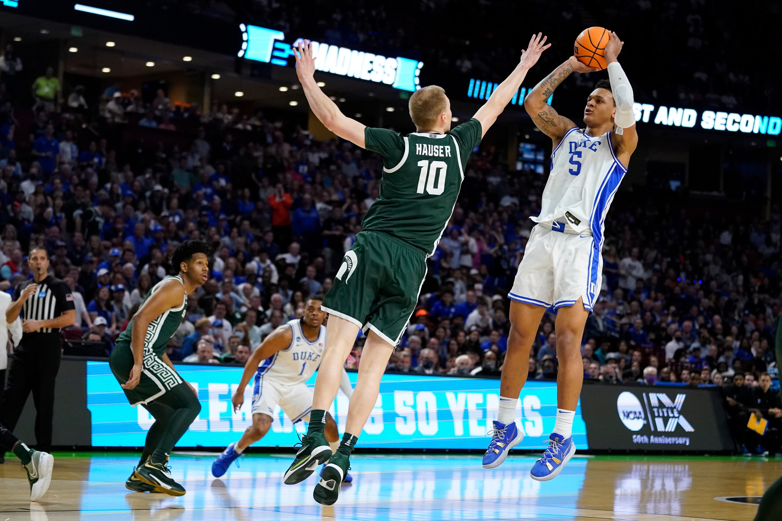 Duke forward Paolo Banchero shoots over Michigan State forward Joey Hauser during the first half of a college basketball game in the second round of the NCAA tournament on Sunday, March 20, 2022, in Greenville, S.C. (AP Photo/Chris Carlson)