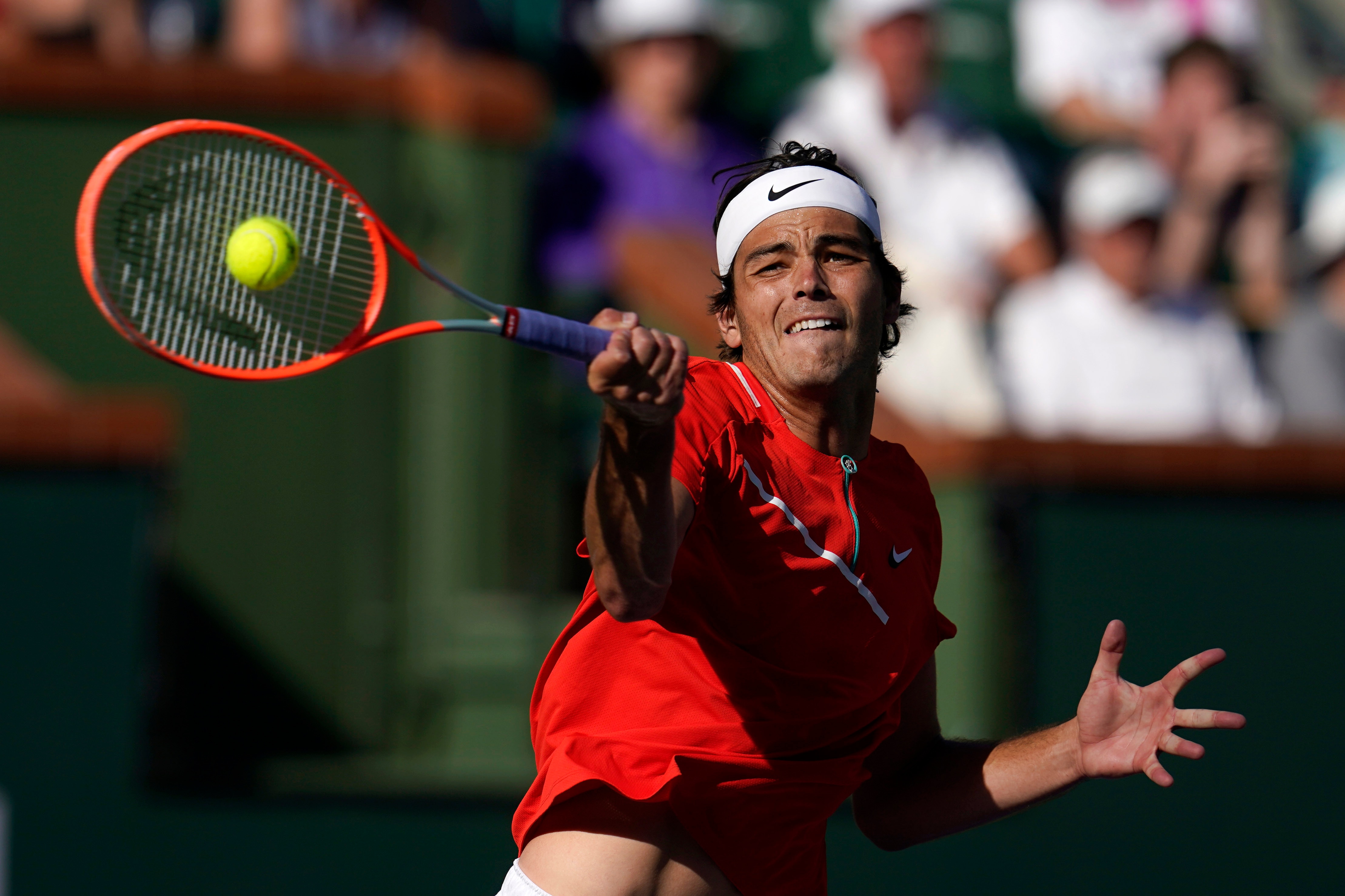 Taylor Fritz returns a shot to Rafael Nadal, of Spain, during the men's singles finals at the BNP Paribas Open tennis tournament Sunday, March 20, 2022, in Indian Wells, Calif. (AP Photo/Marcio Jose Sanchez)