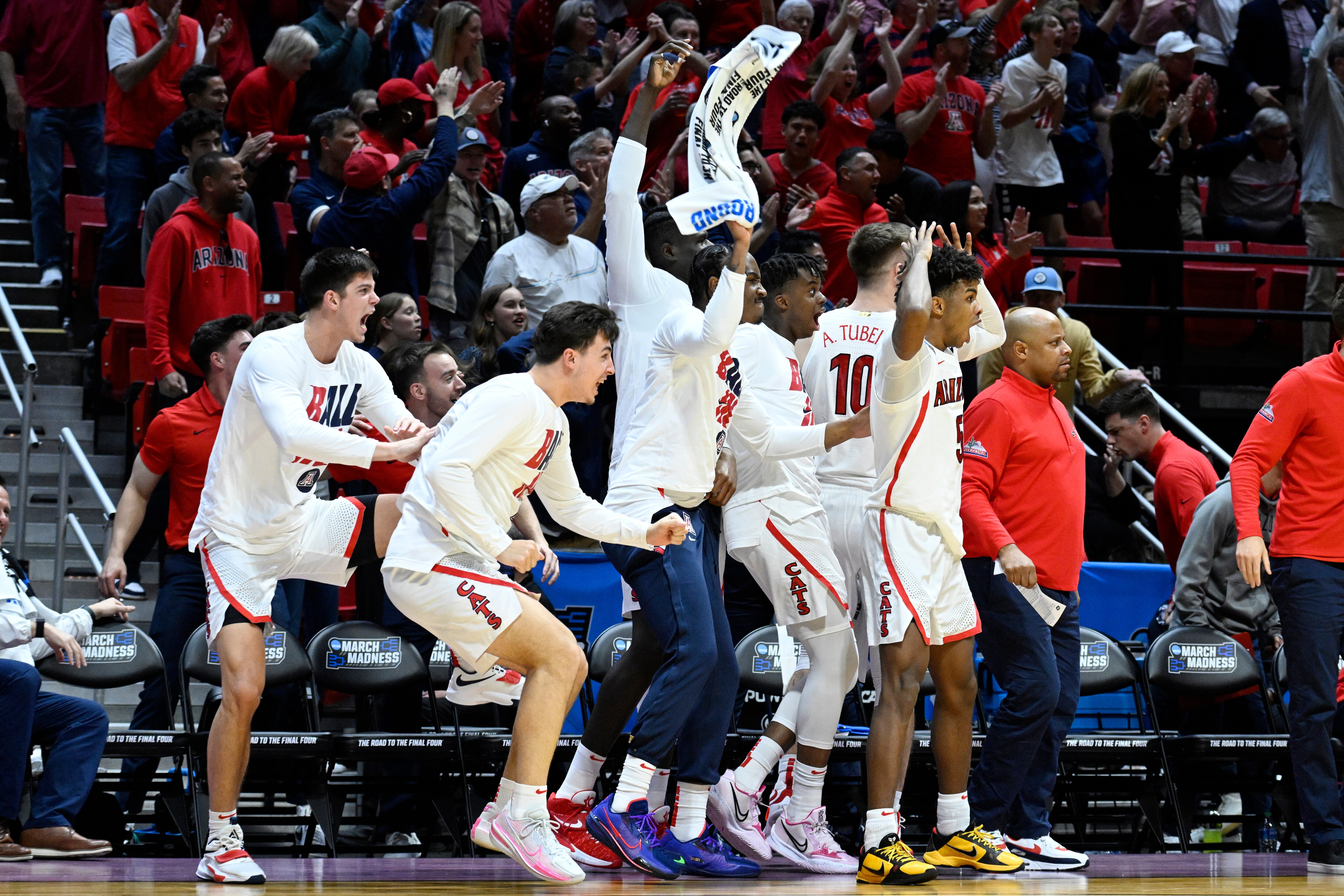 Arizona players react on the bench after a dunk by guard Bennedict Mathurin against TCU during the second half of a second-round NCAA college basketball tournament game, Sunday, March 20, 2022, in San Diego. (AP Photo/Denis Poroy)