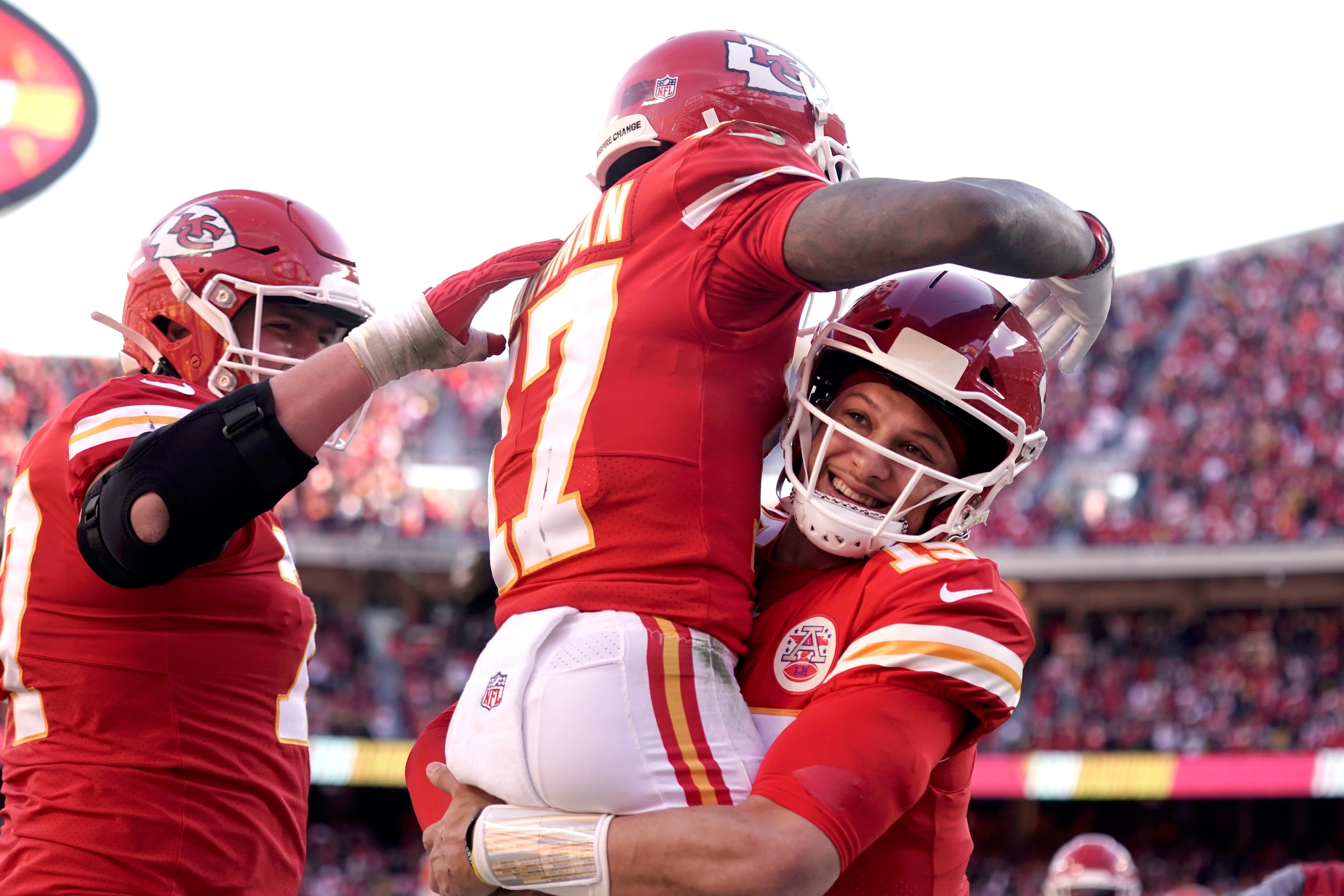 Kansas City Chiefs wide receiver Mecole Hardman (17) celebrates with quarterback Patrick Mahomes, right, after catching a 3-yard touchdown pass during the first half of the AFC championship NFL football game against the Cincinnati Bengals, Sunday, Jan. 30, 2022, in Kansas City, Mo. (AP Photo/Charlie Riedel)