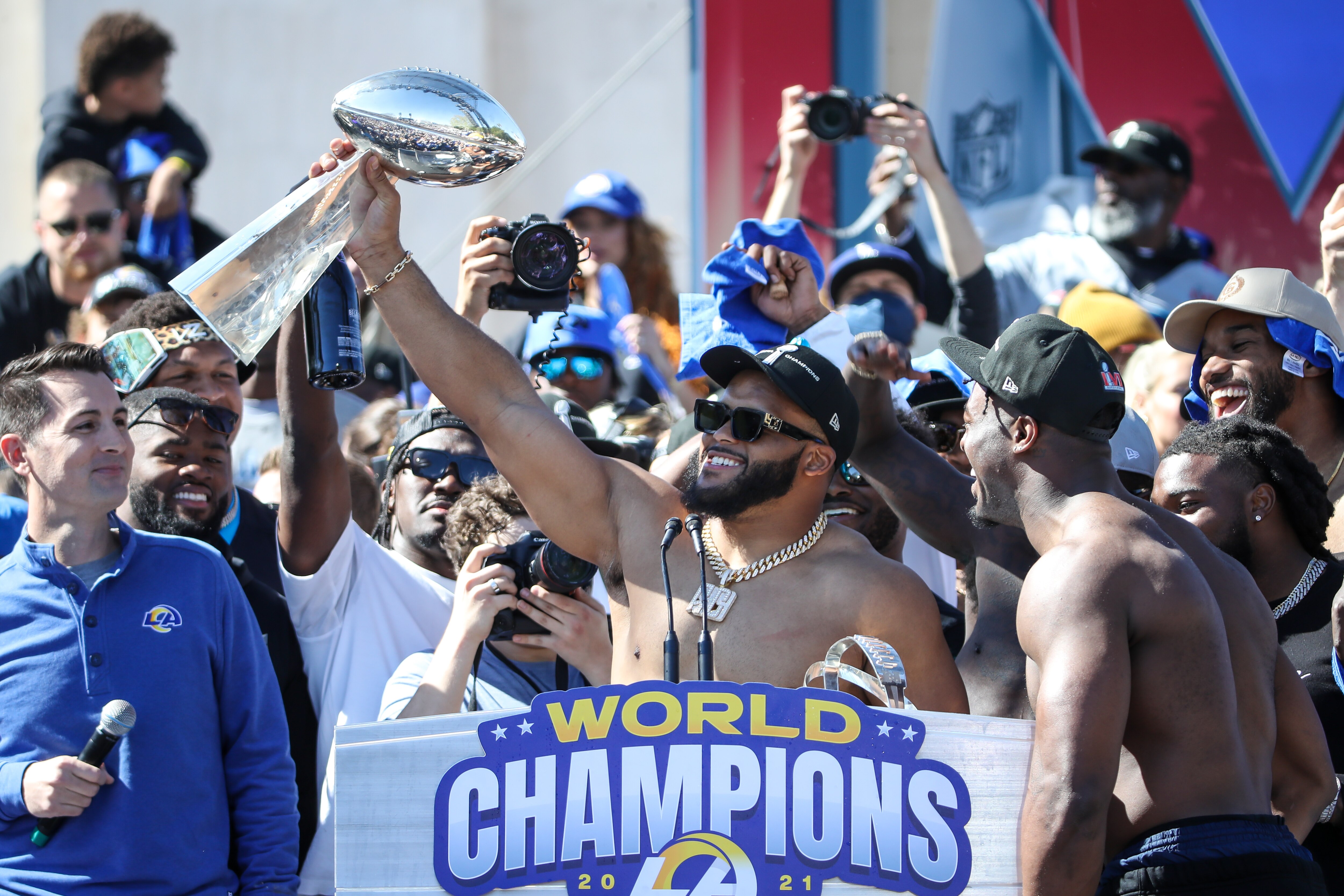 LOS ANGELES, CA - FEBRUARY 16:  Los Angeles Rams defensive end Aaron Donald #99 holds the Lombardi Trophy during the Los Angeles Rams Super Bowl LVI Championship parade on February 16, 2022, at the Los Angeles Memorial Coliseum in Los Angeles, CA. (Photo by Jevone Moore/Icon Sportswire via Getty Images)