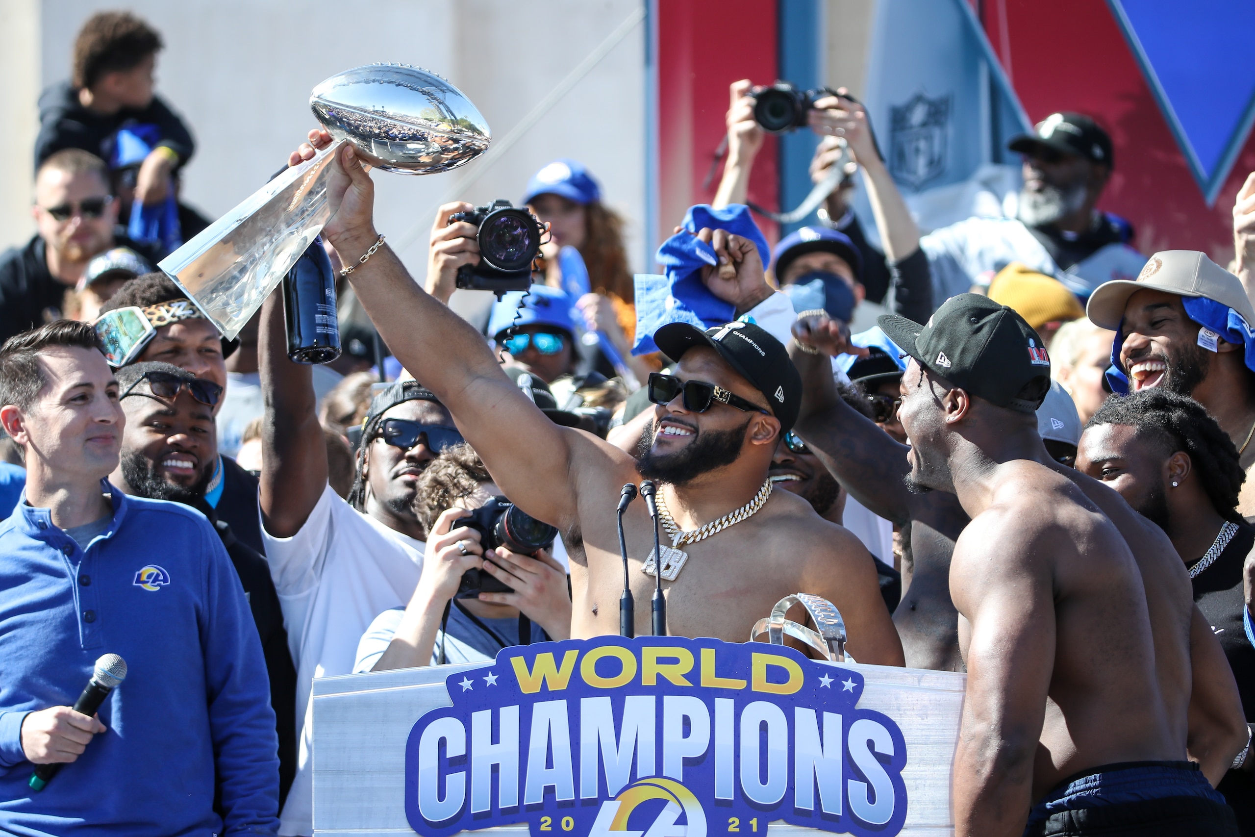 LOS ANGELES, CA - FEBRUARY 16:  Los Angeles Rams defensive end Aaron Donald #99 holds the Lombardi Trophy during the Los Angeles Rams Super Bowl LVI Championship parade on February 16, 2022, at the Los Angeles Memorial Coliseum in Los Angeles, CA. (Photo by Jevone Moore/Icon Sportswire via Getty Images)