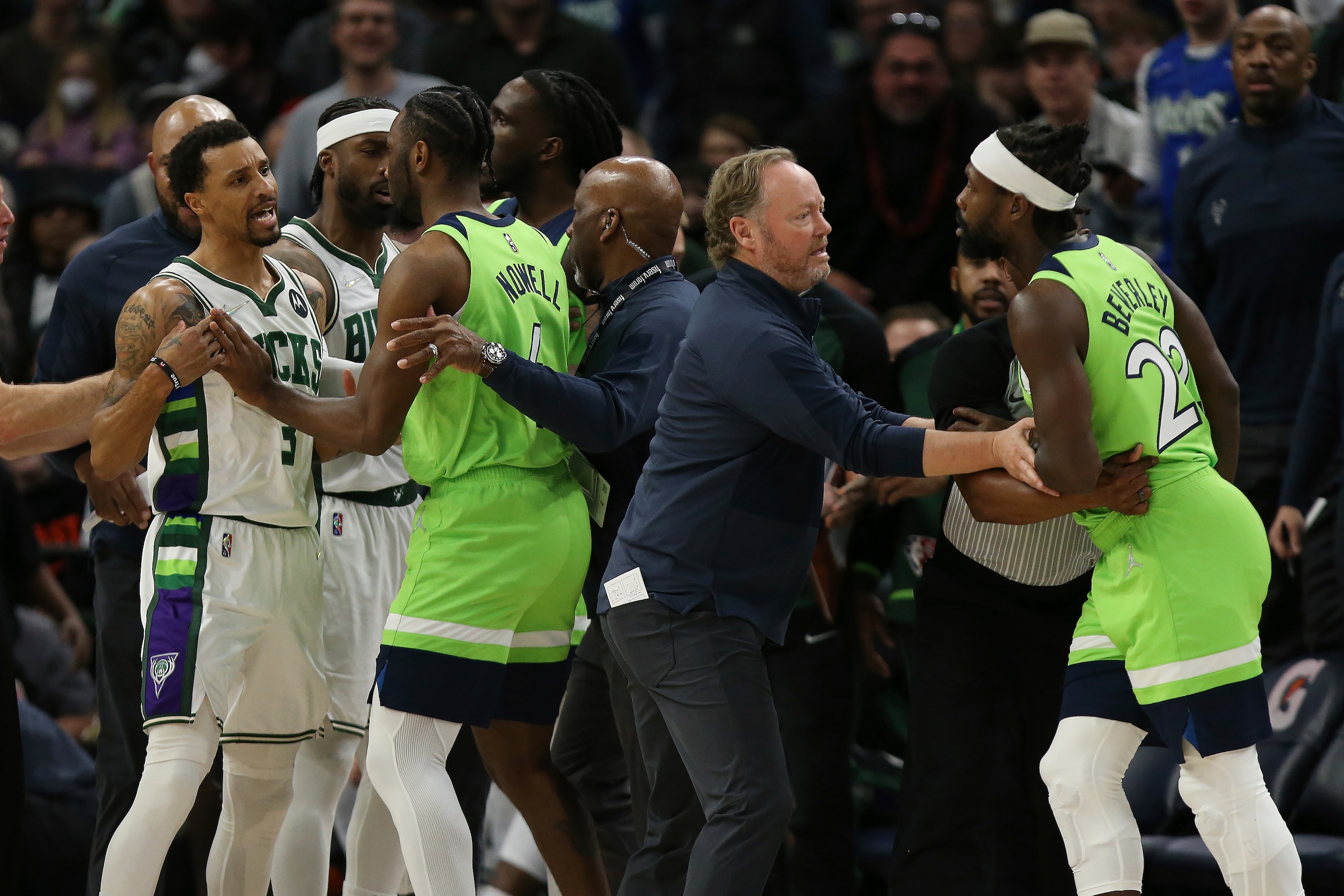 Milwaukee Bucks guard George Hill (3) argues with Minnesota Timberwolves guard Patrick Beverley (22) during the first half of an NBA basketball game Saturday, March 19, 2022, in Minneapolis. Hill and Beverley were ejected from the game. (AP Photo/Stacy Bengs)