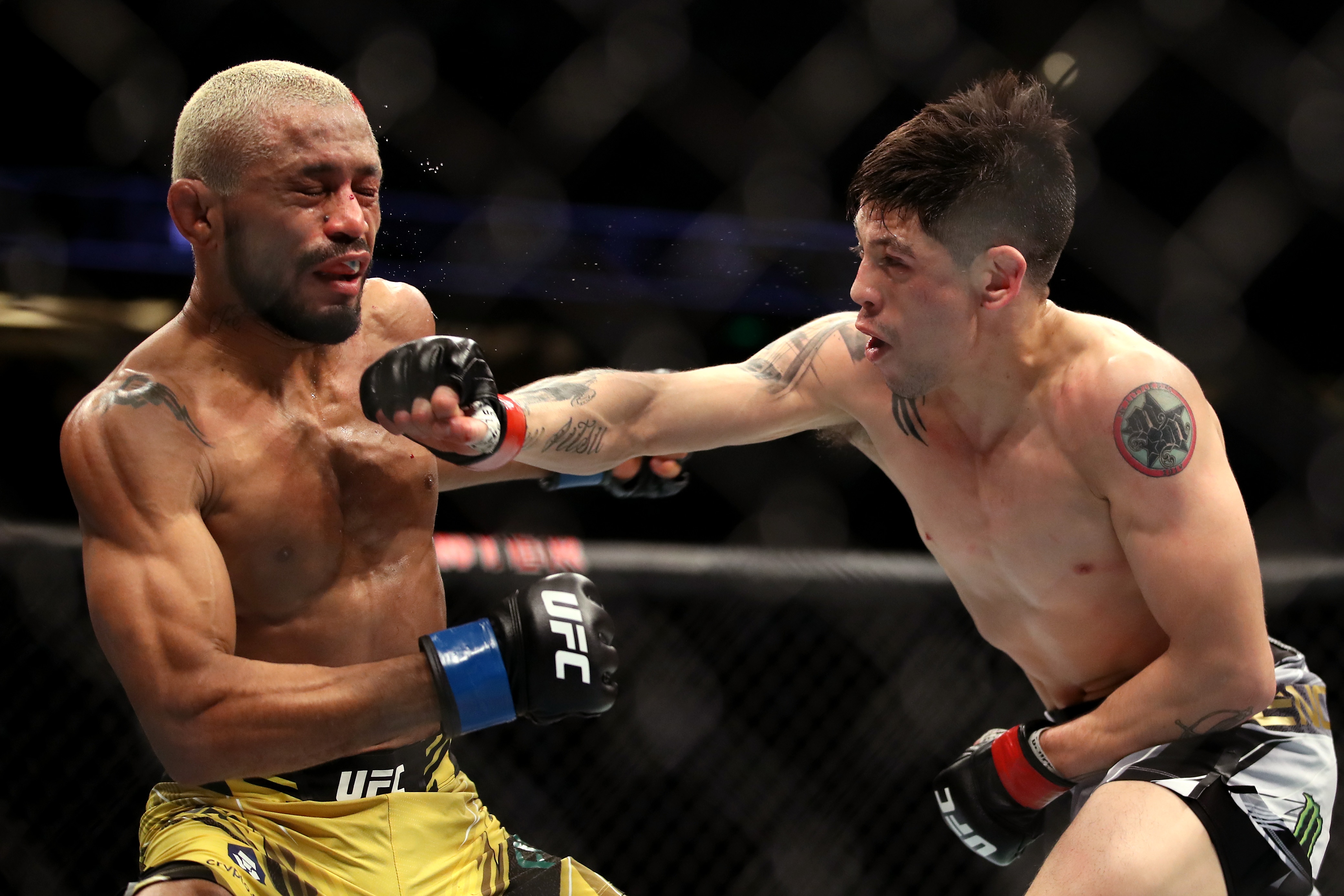 ANAHEIM, CALIFORNIA - JANUARY 22: Brandon Moreno of Mexico (right) punches Deiveson Figueiredo of Brazil in their flyweight title fight during the UFC 270 event at Honda Center on January 22, 2022 in Anaheim, California. (Photo by Katelyn Mulcahy/Getty Images)