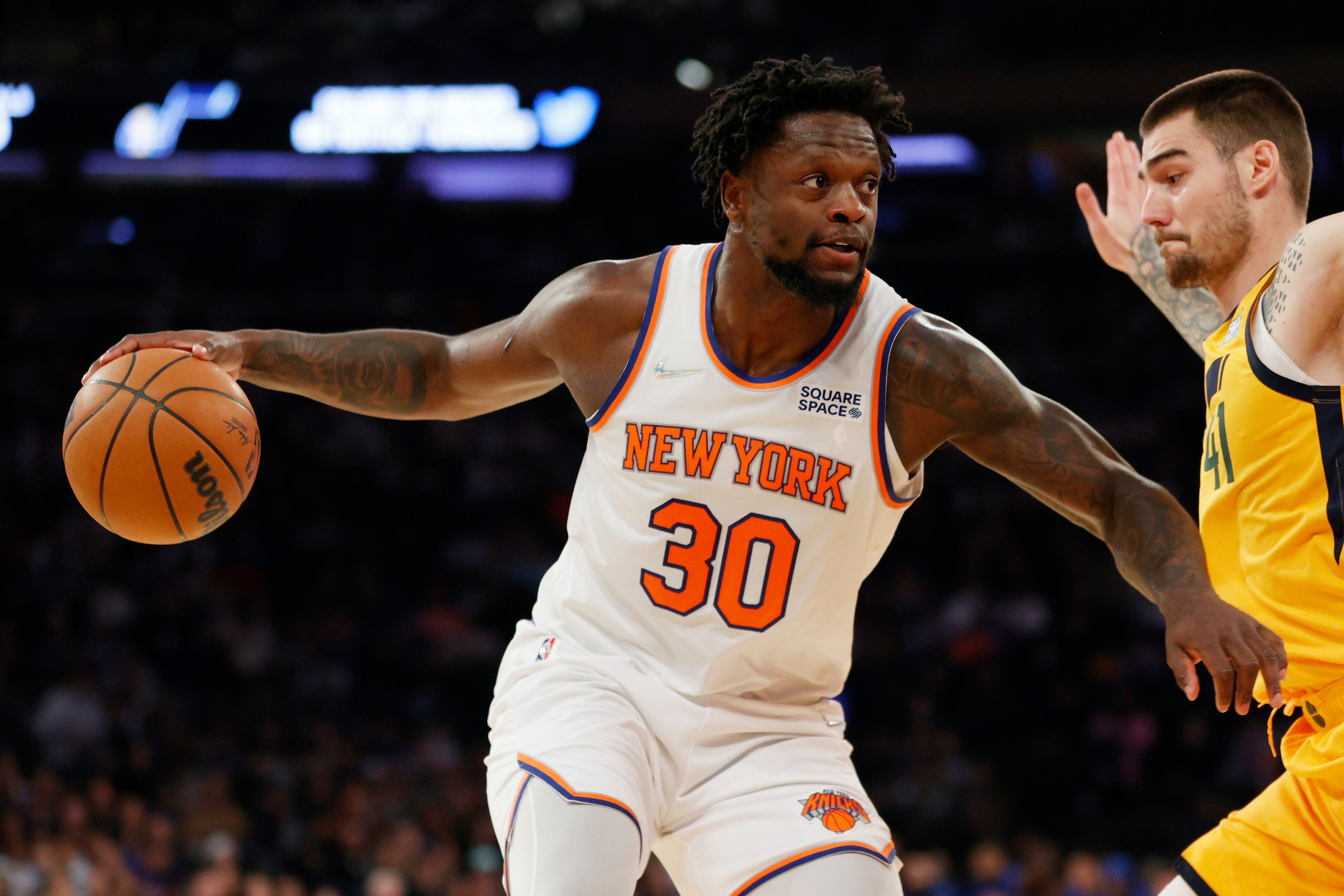 NEW YORK, NEW YORK - MARCH 20: Julius Randle #30 of the New York Knicks dribbles as Juancho Hernangomez #41 of the Utah Jazz defends during the first half at Madison Square Garden on March 20, 2022 in New York City. NOTE TO USER: User expressly acknowledges and agrees that, by downloading and or using this photograph, User is consenting to the terms and conditions of the Getty Images License Agreement. (Photo by Sarah Stier/Getty Images)