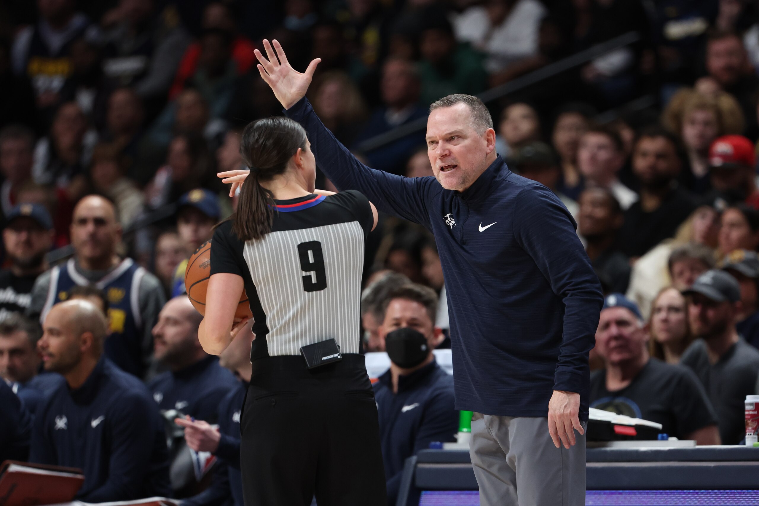 DENVER, CO - MARCH 22: Michael Malone head coach of the Denver Nuggets talks to referee Natalie Sago #9 while facing the Los Angeles Clippers at Ball Arena on March 22, 2022 in Denver, Colorado. NOTE TO USER: User expressly acknowledges and agrees that, by downloading and or using this photograph, User is consenting to the terms and conditions of the Getty Images License Agreement (Photo by Isaiah Vazquez/Clarkson Creative/Getty Images)