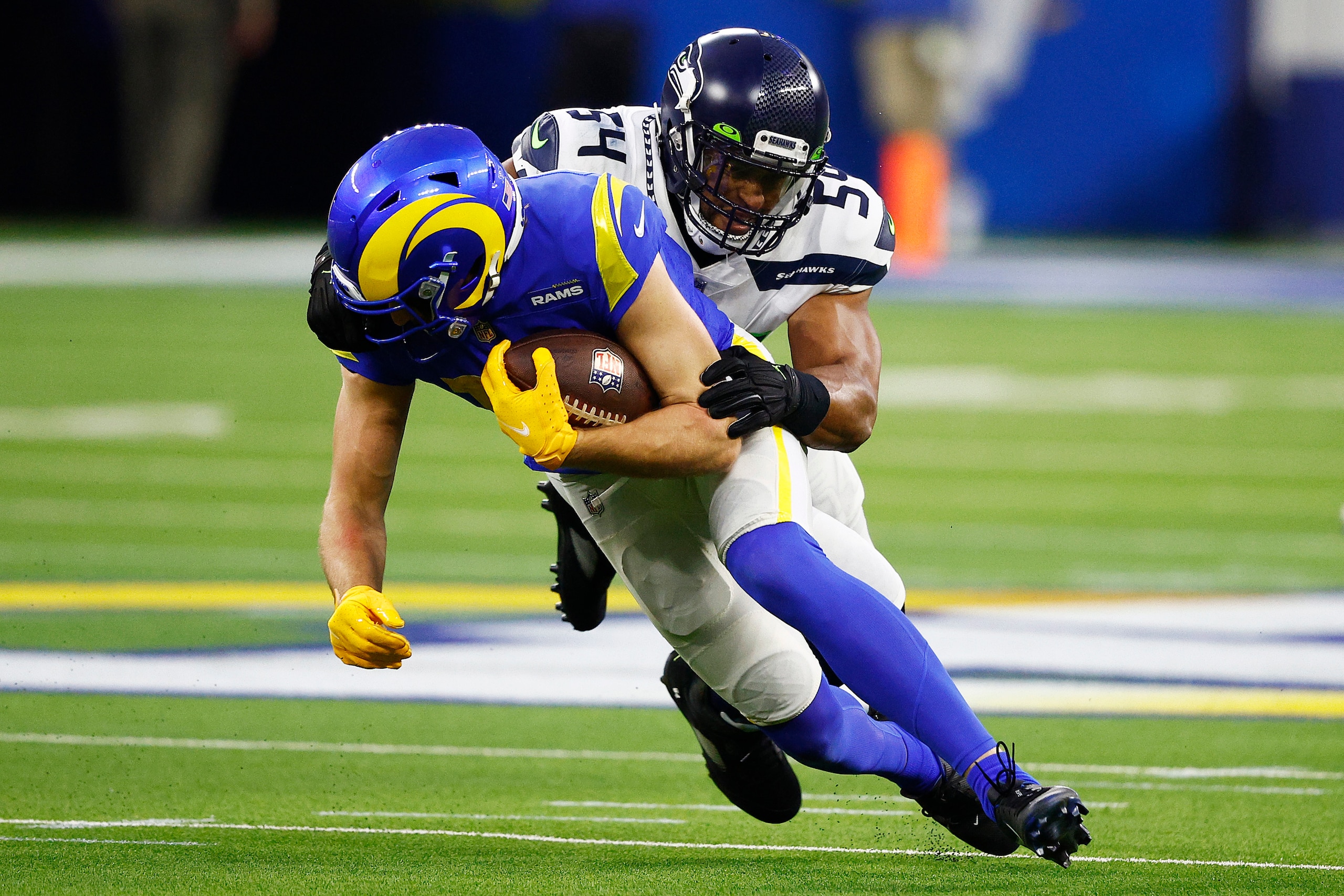 INGLEWOOD, CALIFORNIA - DECEMBER 21: Ben Skowronek #18 of the Los Angeles Rams is tackled by Bobby Wagner #54 of the Seattle Seahawks in the first quarter of the game at SoFi Stadium on December 21, 2021 in Inglewood, California. (Photo by Ronald Martinez/Getty Images)