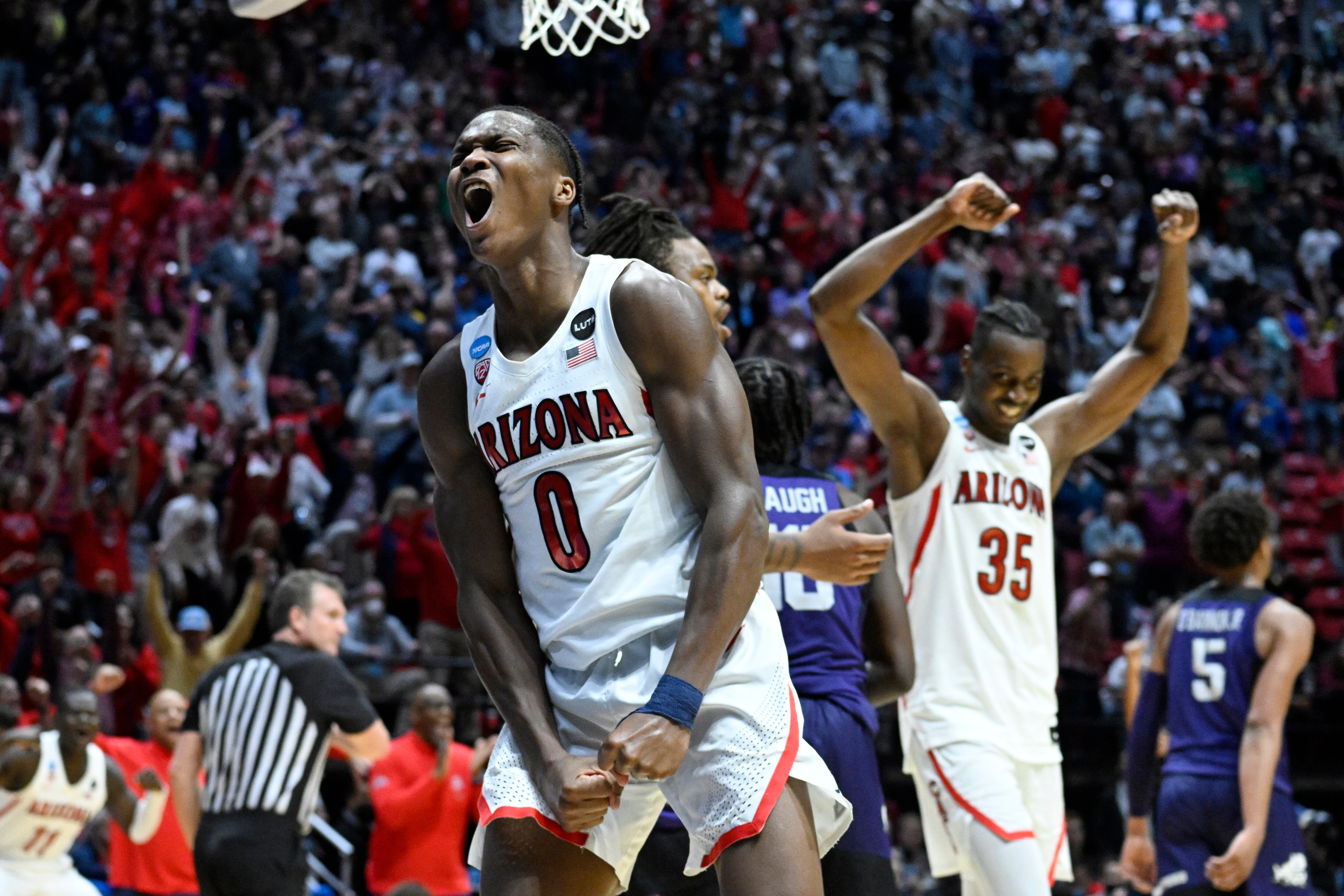 Arizona guard Bennedict Mathurin (0) and center Christian Koloko (35) react at the end of overtime in a second-round NCAA college basketball tournament game against TCU, Sunday, March 20, 2022, in San Diego. Arizona won 85-80. (AP Photo/Denis Poroy)