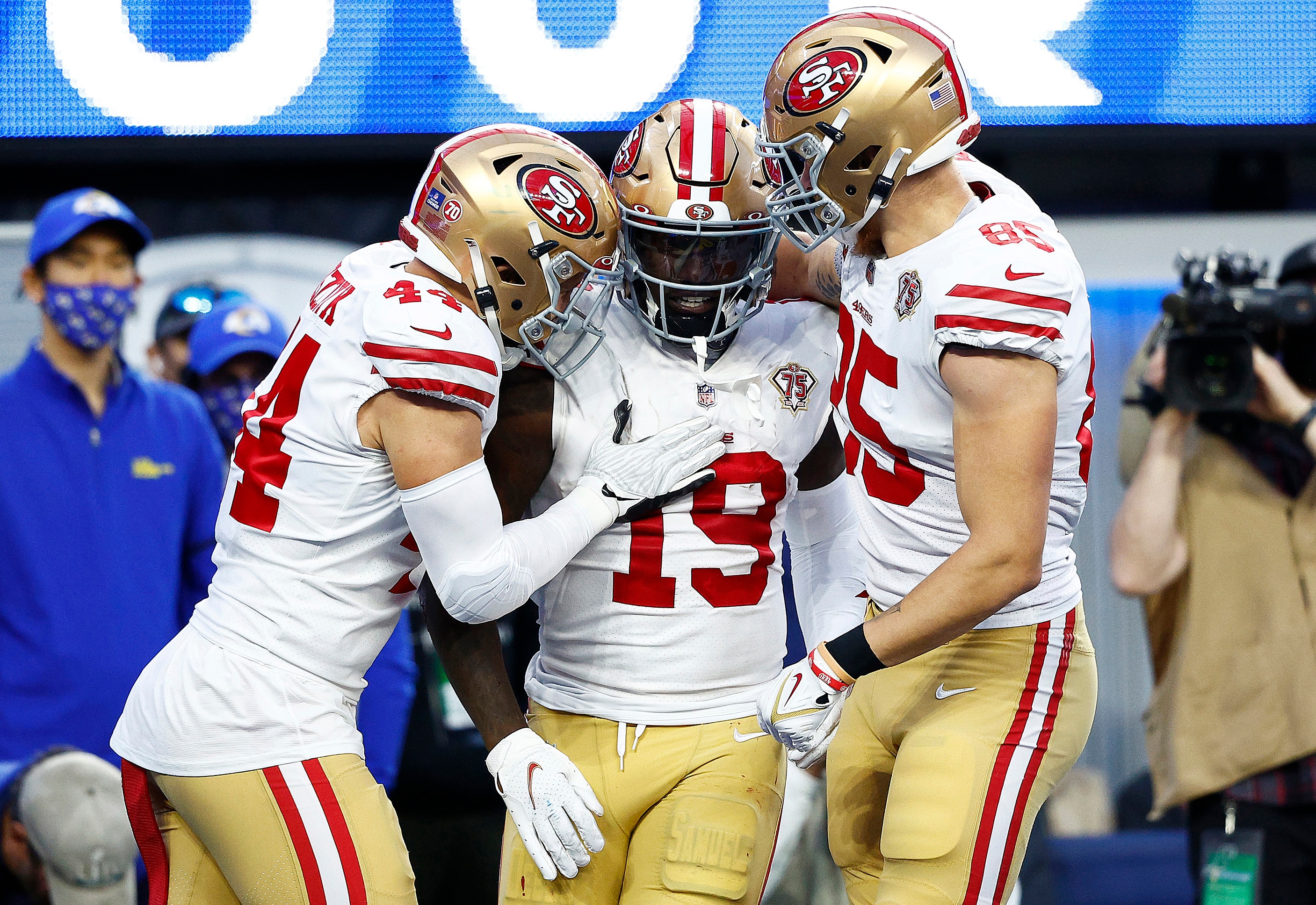 INGLEWOOD, CALIFORNIA - JANUARY 30: Deebo Samuel #19 of the San Francisco 49ers reacts with teammates Kyle Juszczyk #44 and George Kittle #85 after scoring a touchdown in the second quarter against the Los Angeles Rams in the NFC Championship Game at SoFi Stadium on January 30, 2022 in Inglewood, California. (Photo by Ronald Martinez/Getty Images)