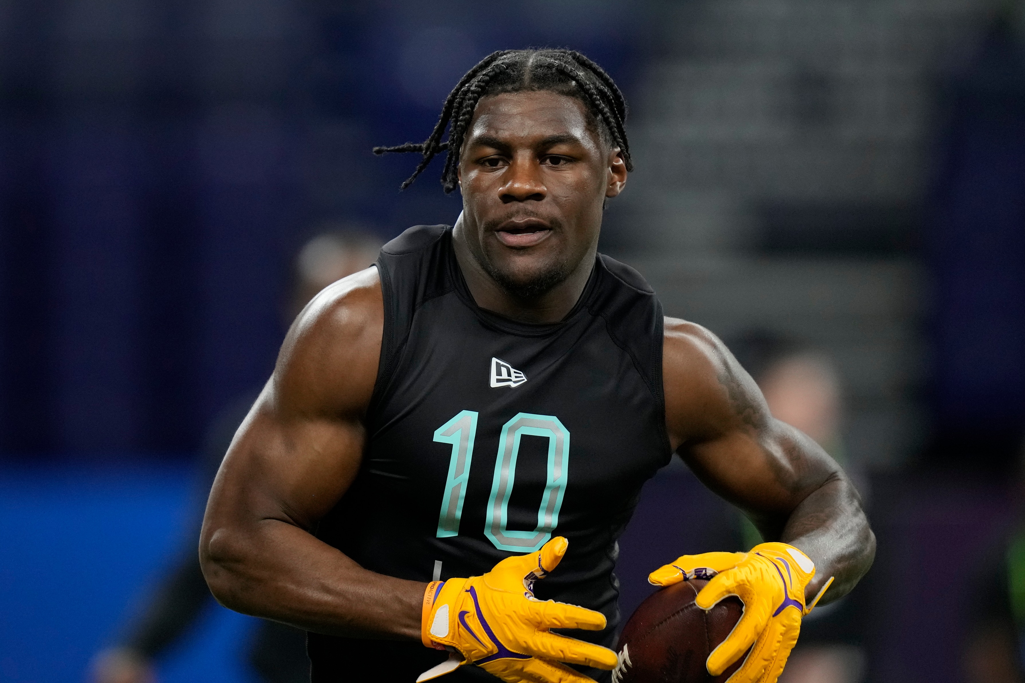 LSU linebacker Damone Clark runs a drill at the NFL football scouting combine, Saturday, March 5, 2022, in Indianapolis. (AP Photo/Charlie Neibergall)