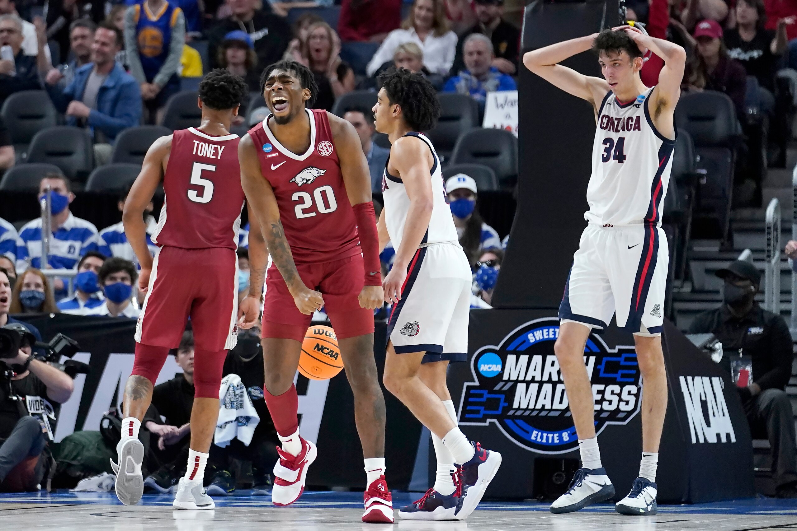 Arkansas forward Kamani Johnson (20) celebrates in front of Gonzaga center Chet Holmgren (34) during the second half of a college basketball game in the Sweet 16 round of the NCAA tournament in San Francisco, Thursday, March 24, 2022. (AP Photo/Marcio Jose Sanchez)