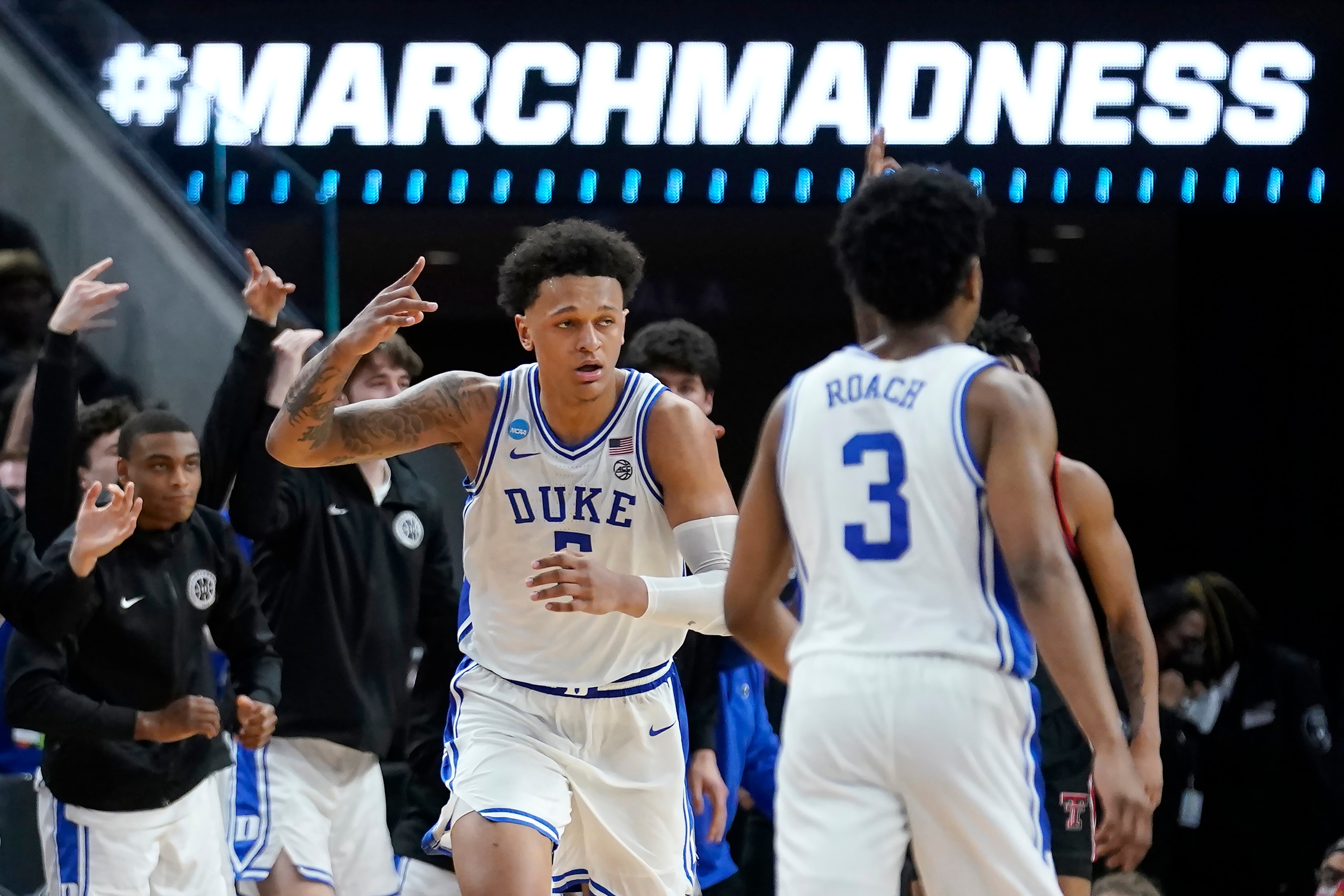 Duke forward Paolo Banchero, middle, celebrates after shooting a three point basket against Texas Tech during the second half of a college basketball game in the Sweet 16 round of the NCAA tournament in San Francisco, Thursday, March 24, 2022. (AP Photo/Marcio Jose Sanchez)